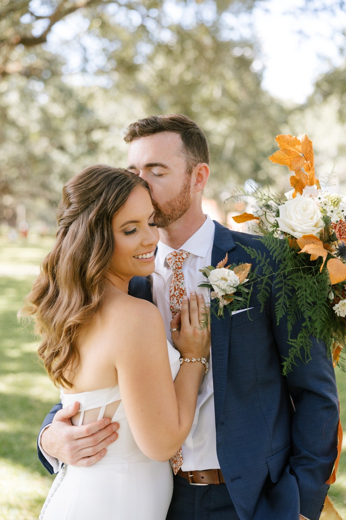 Romantic timeless bride and groom in navy and orange suit 