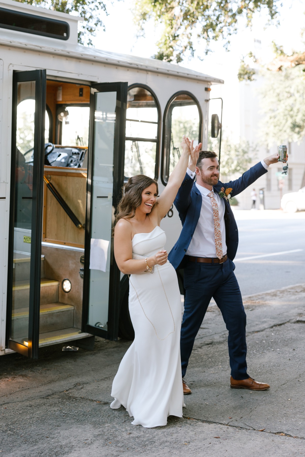 Bride and groom exiting vintage wedding trolley transportation