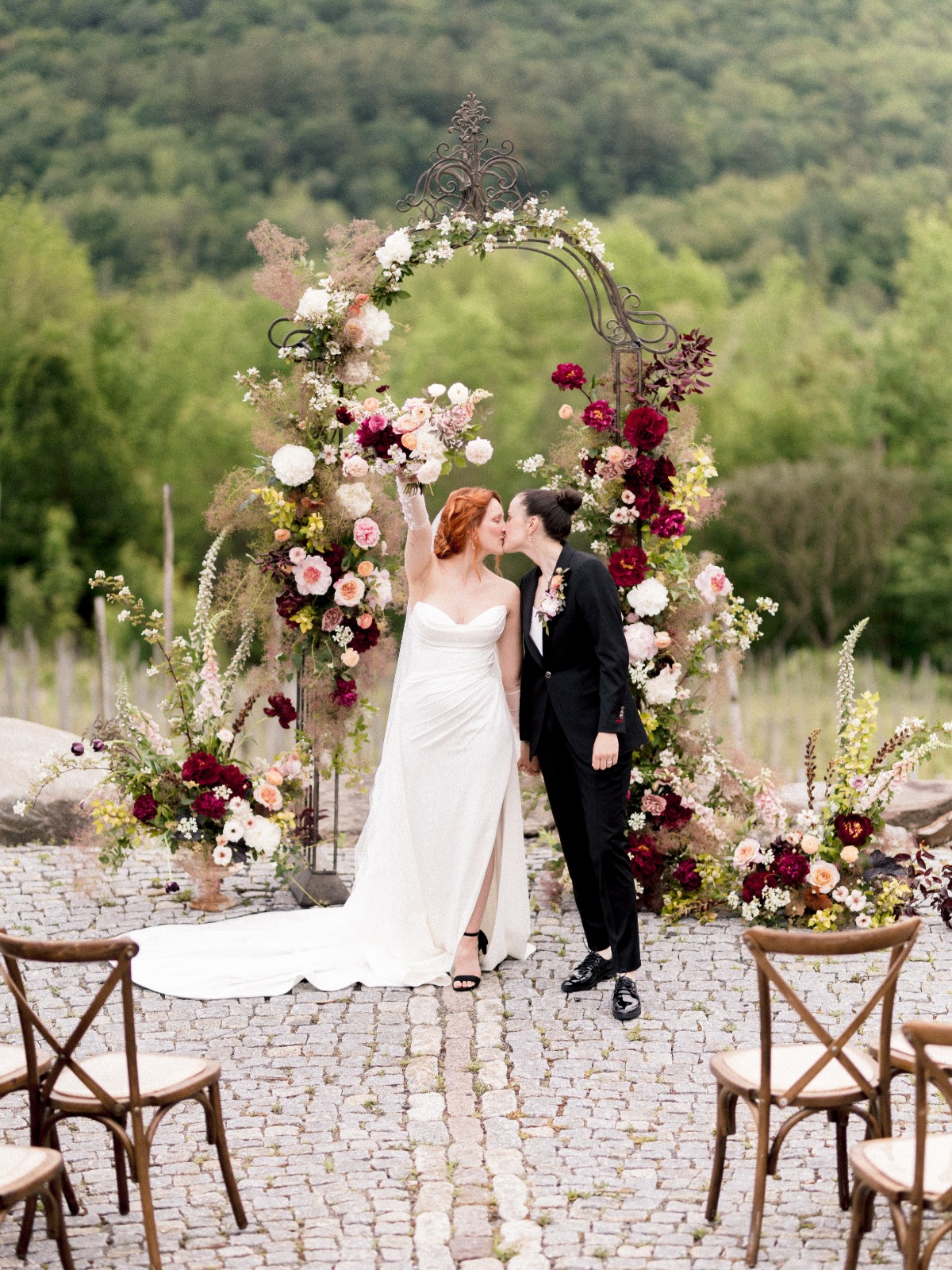 marron and white floral arch with feathered details