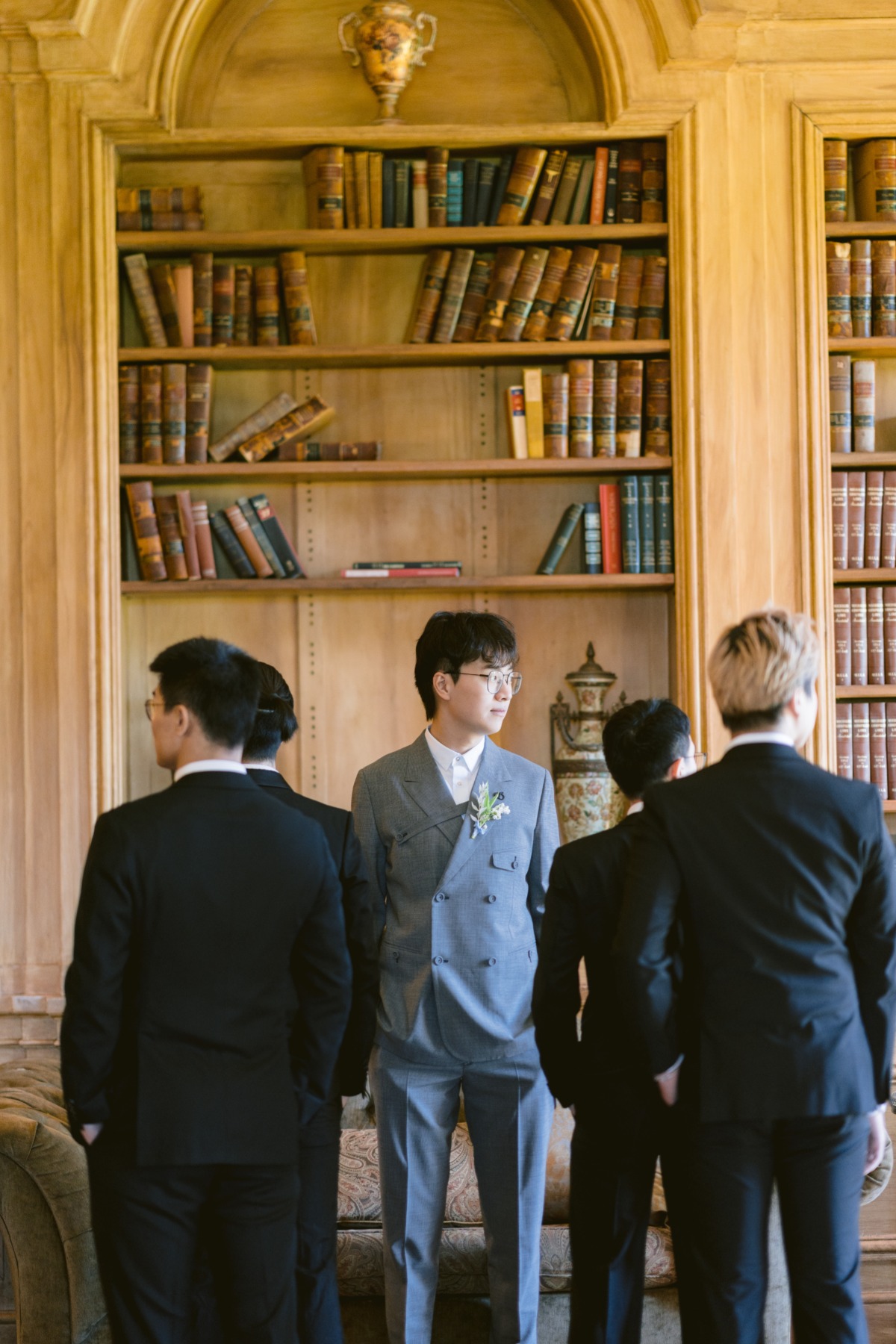 groom with groomsmen in castle library