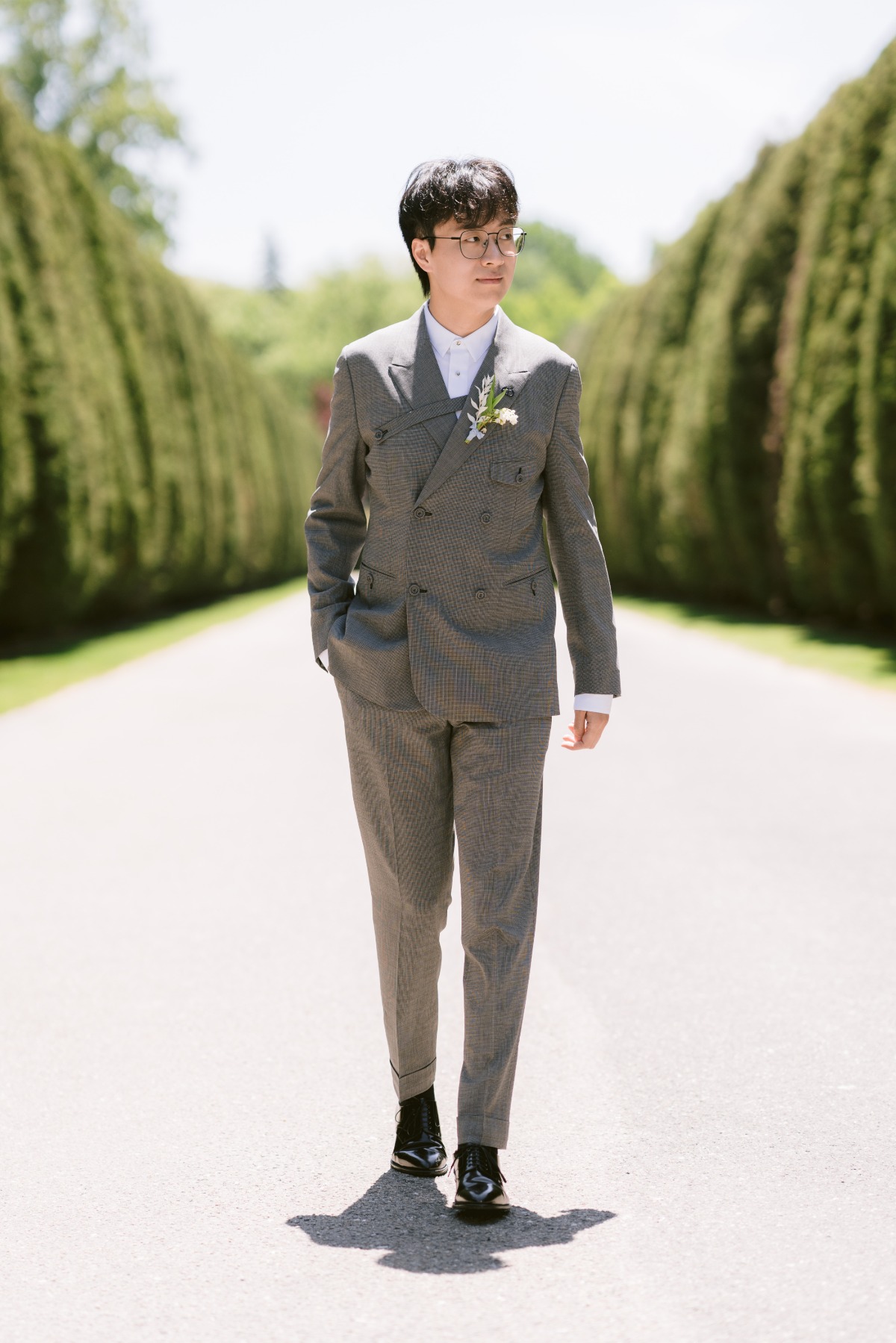 groom in dior suit in castle garden