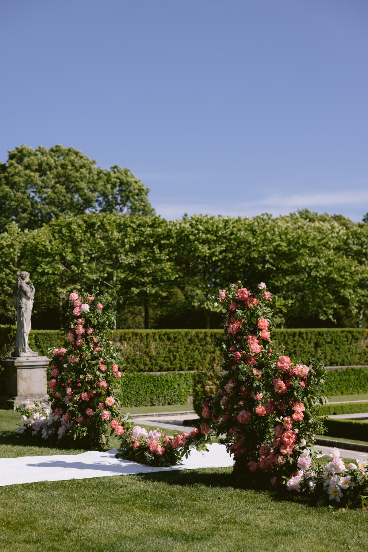 coral peony floral arch for wedding ceremony