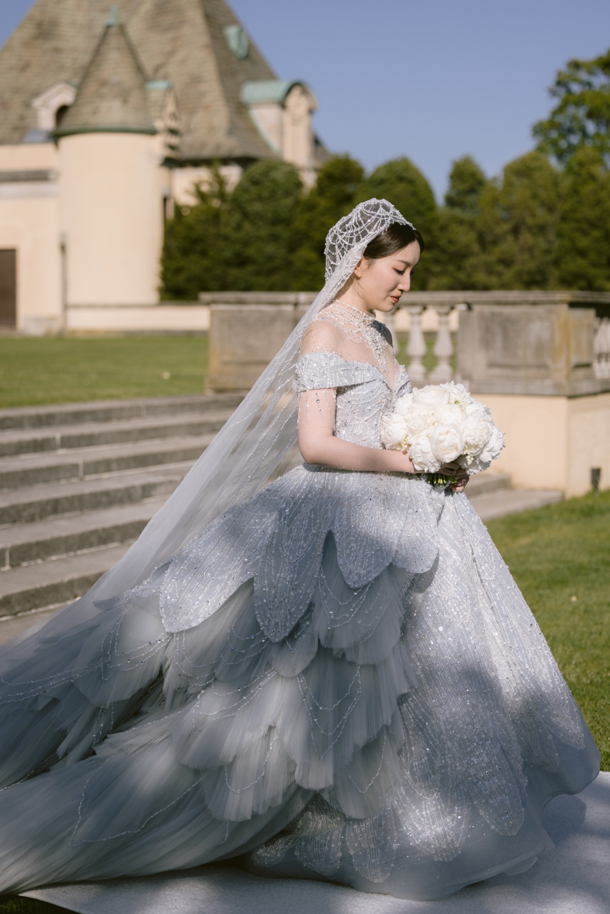 cinderella bride in blue beaded ballgown in garden