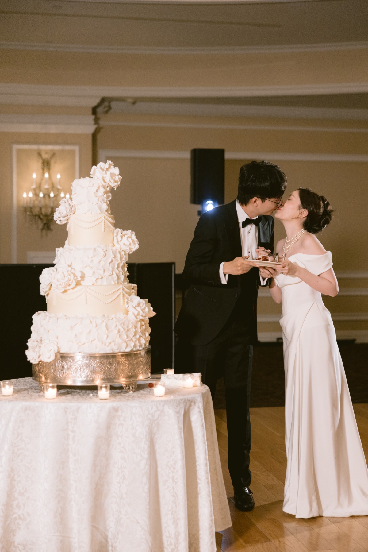 bride and groom cut grand ivory wedding cake