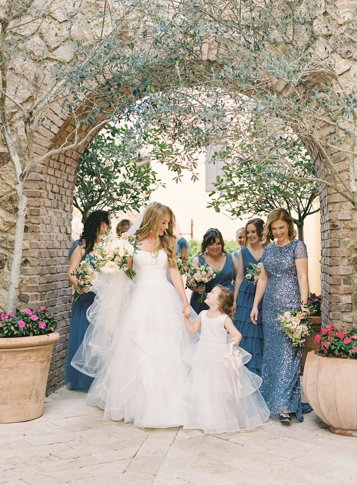 Elegant bride with mix and match bridesmaids in dark blue