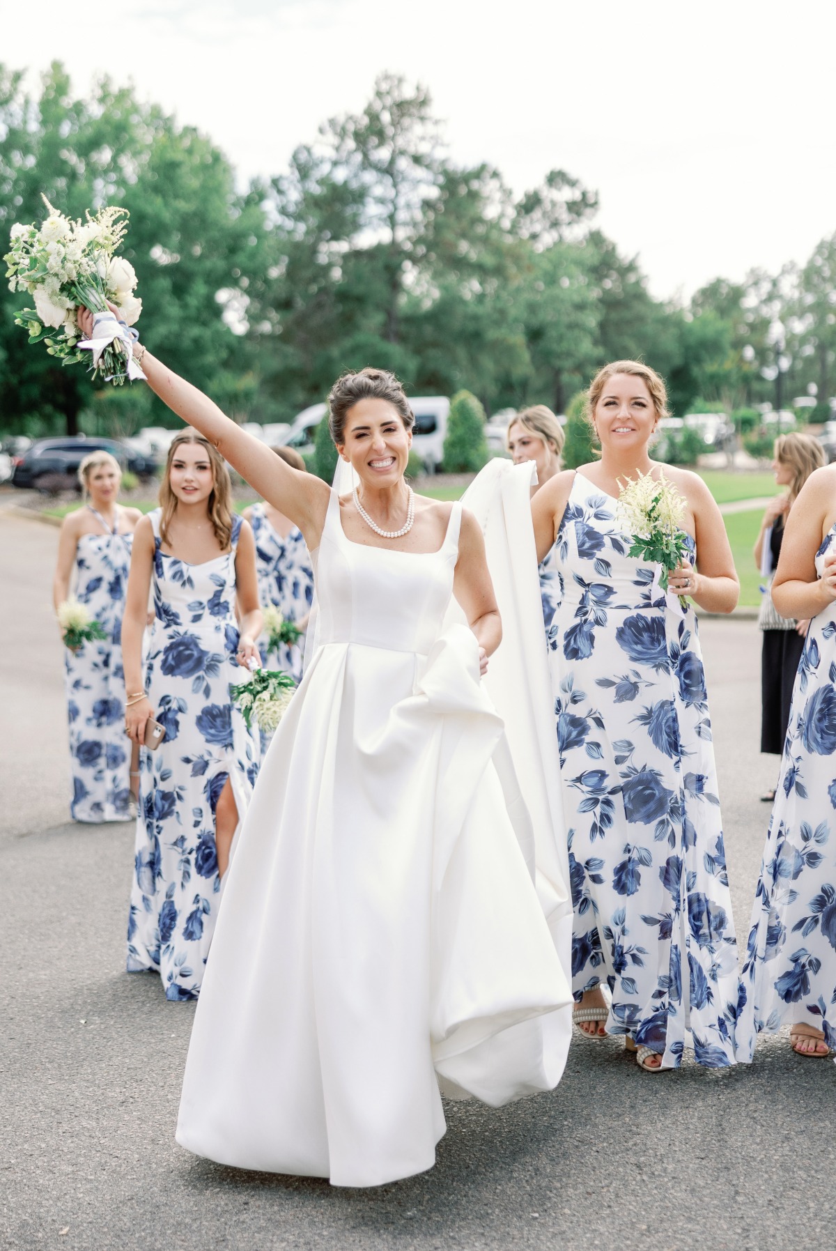 bride and bridesmaids in blue and white floral dresses