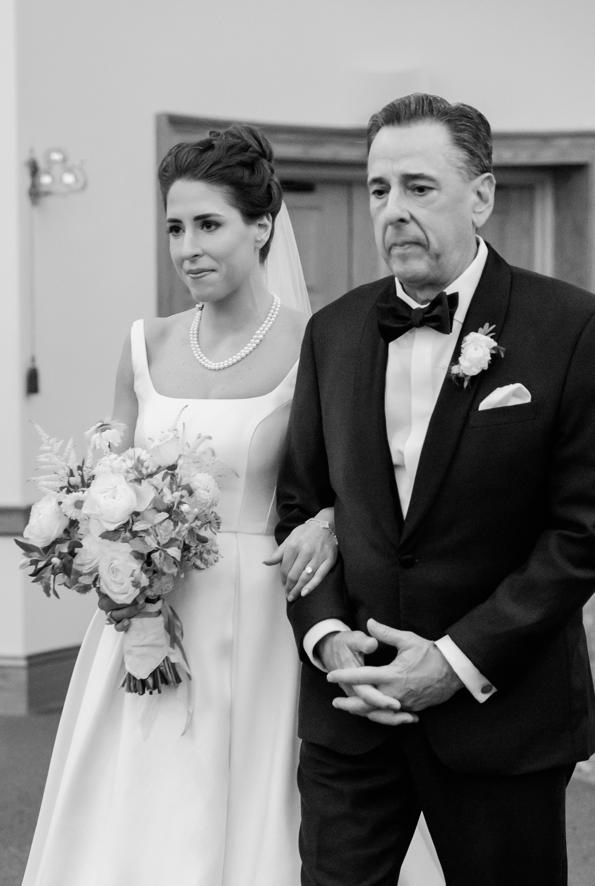 father walking bride down the aisle in church wedding 