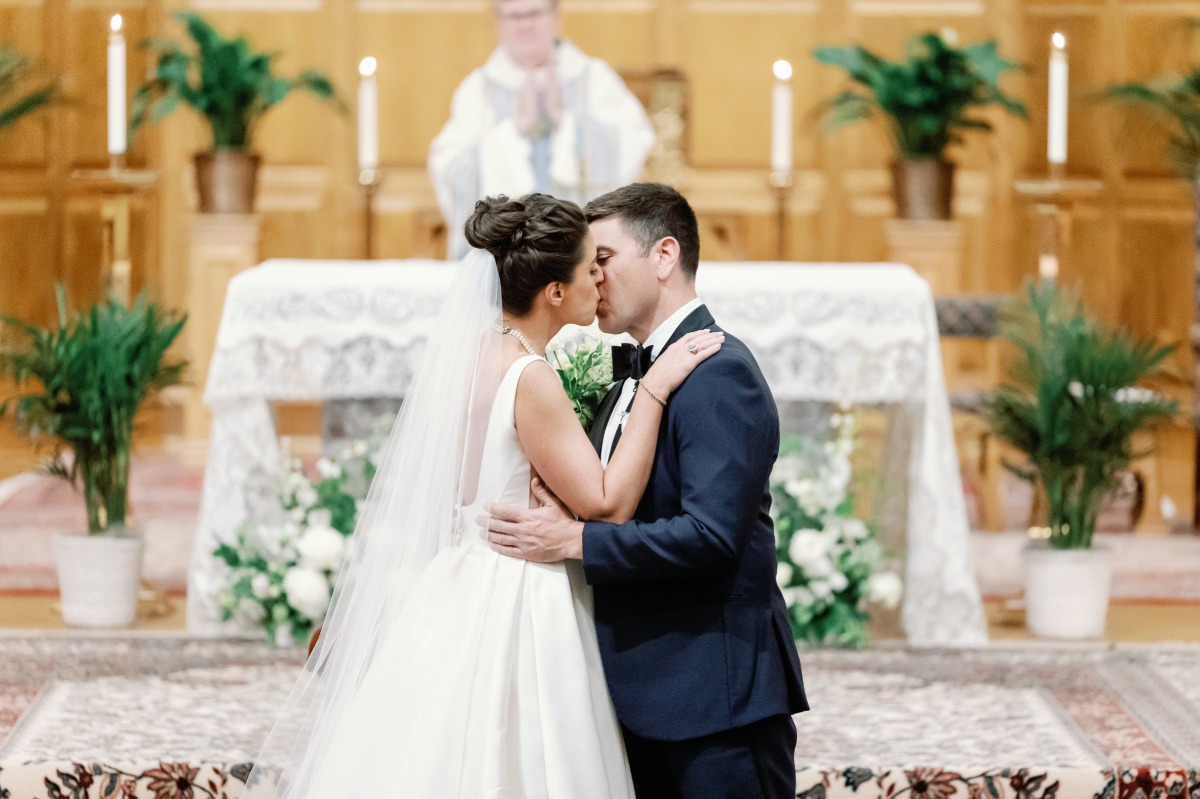 bride and groom kiss at church wedding in north carolina