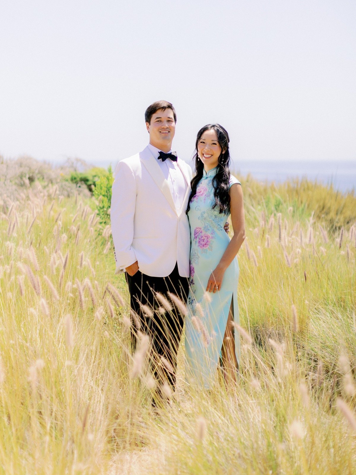 bride in blue quipao with lavender embroidery and groom in white tux