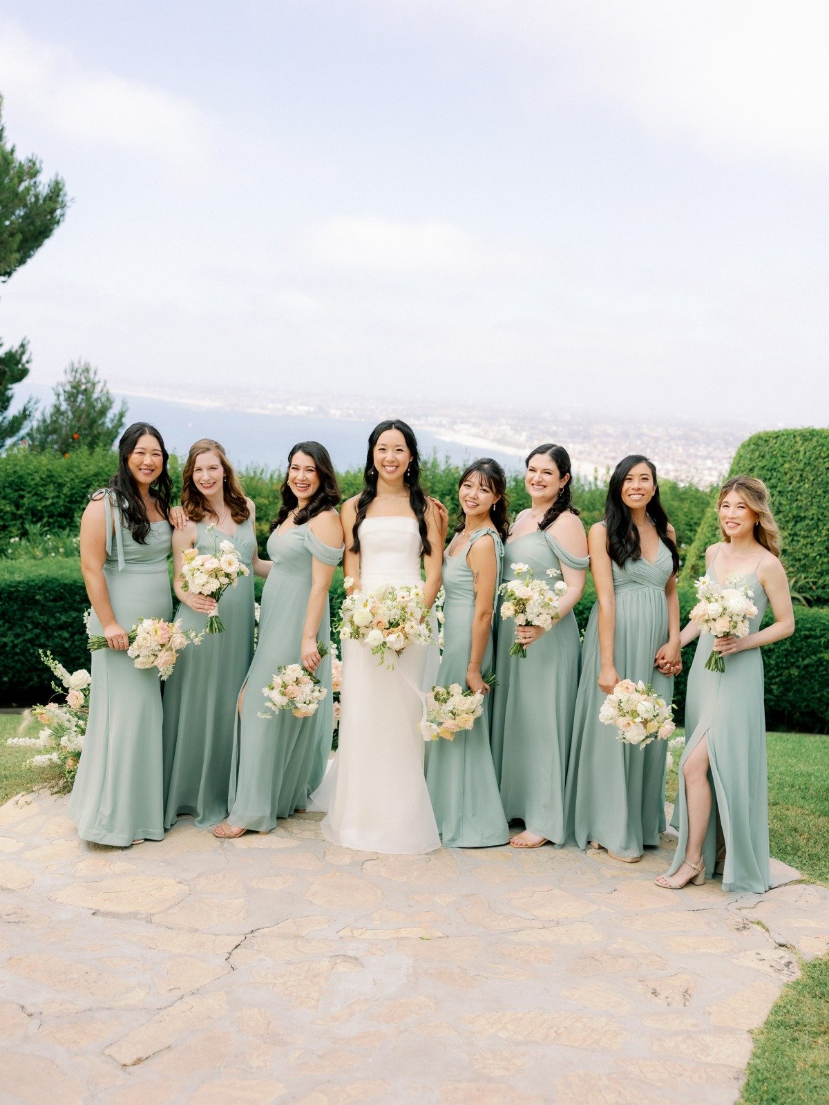 bride and her bridesmaids in sage dresses