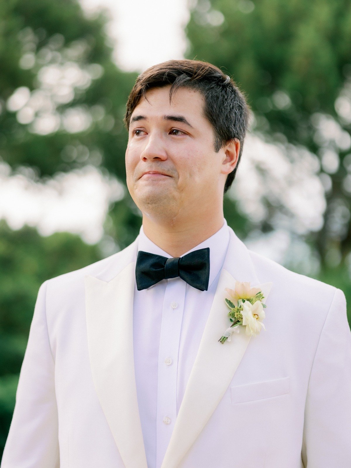 groom tearing up as he sees bride walking down aisle