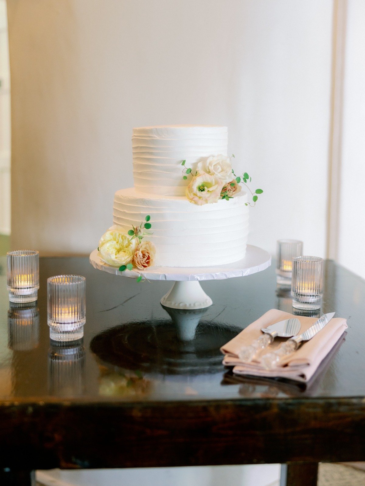 simple buttercream wedding cake with fresh flowers