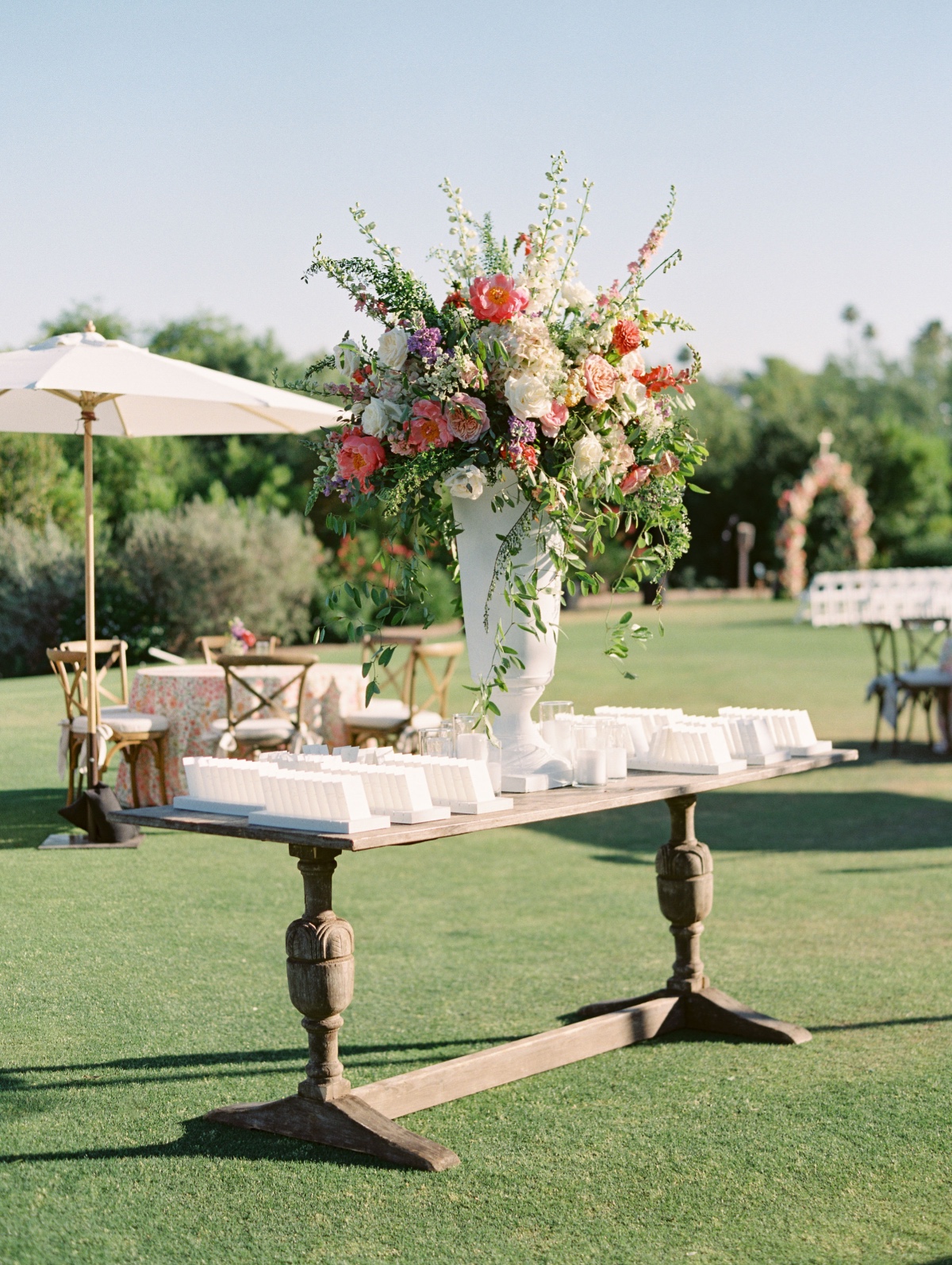 large summer floral arrangement in tall white vase