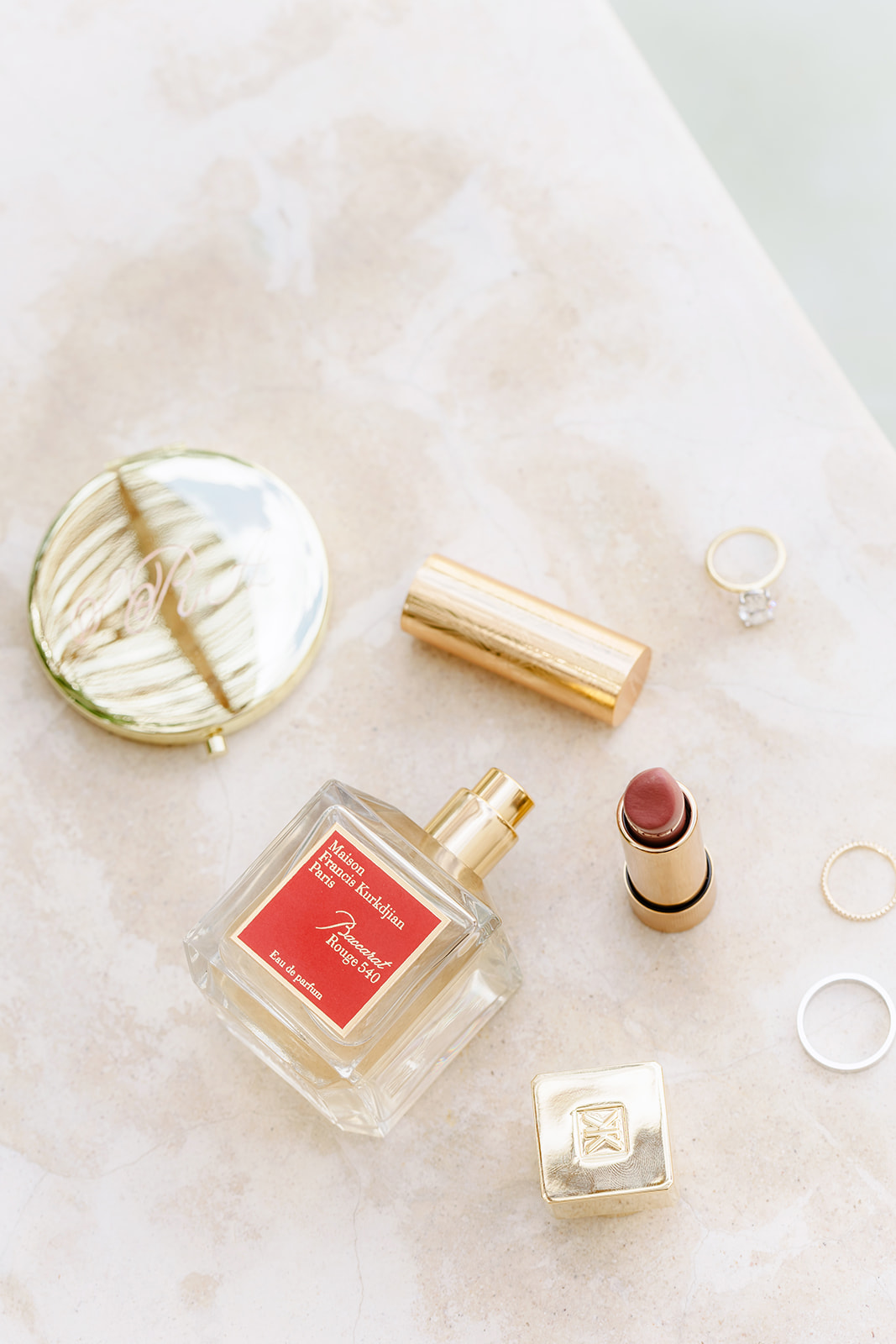 Luxury bridal perfume, lipstick, and gold compact for getting ready