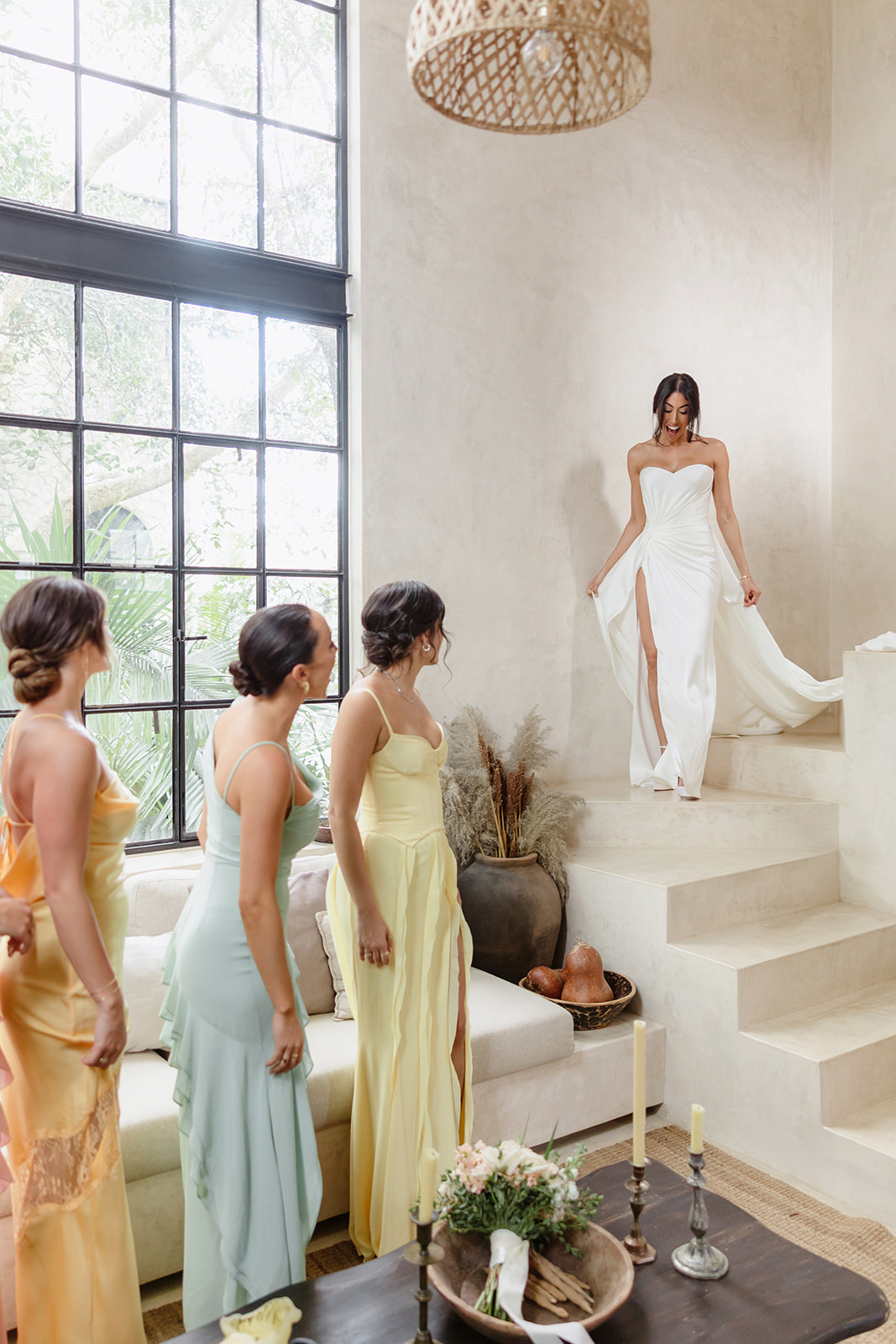Bride first look with pastel rainbow bridesmaids in Tulum