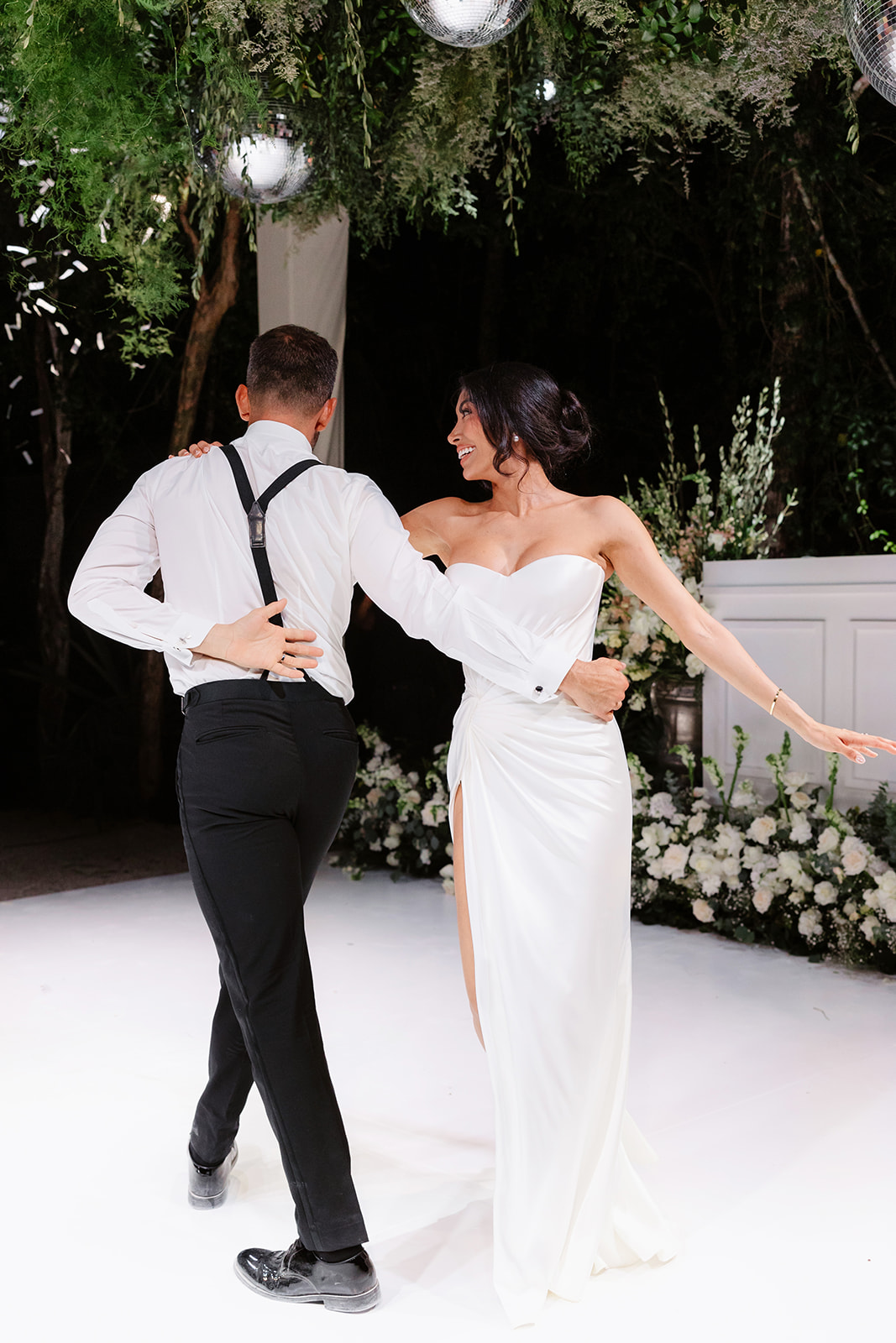 First dance on dance floor surrounded by white roses in Tulum 