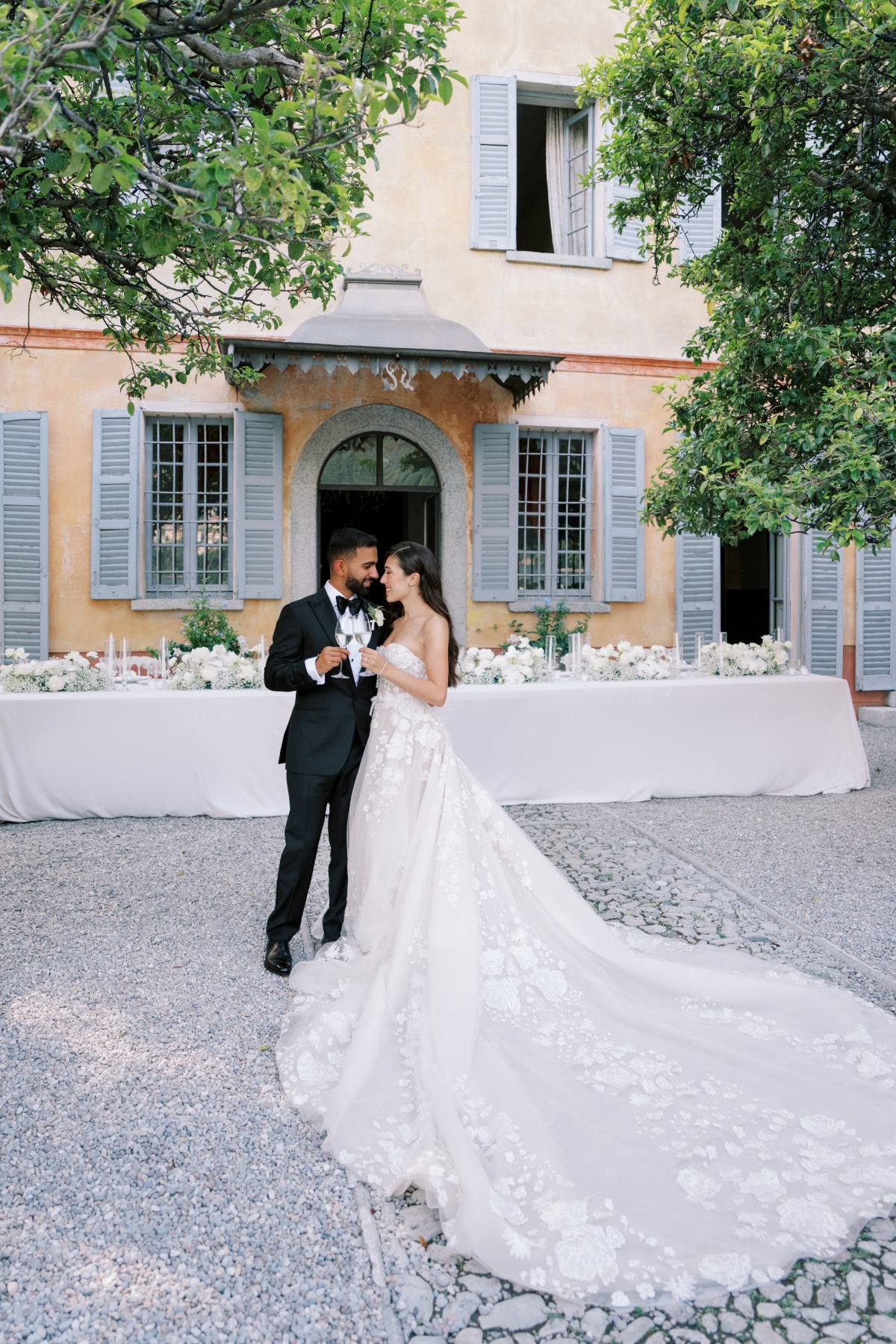 bride and groom in front of villa for reception