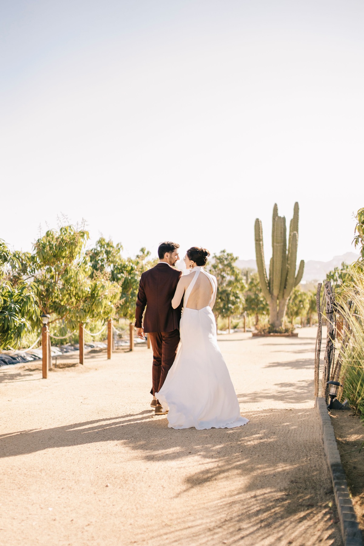 Gorgeous Cabo wedding couple walking into the sunset 