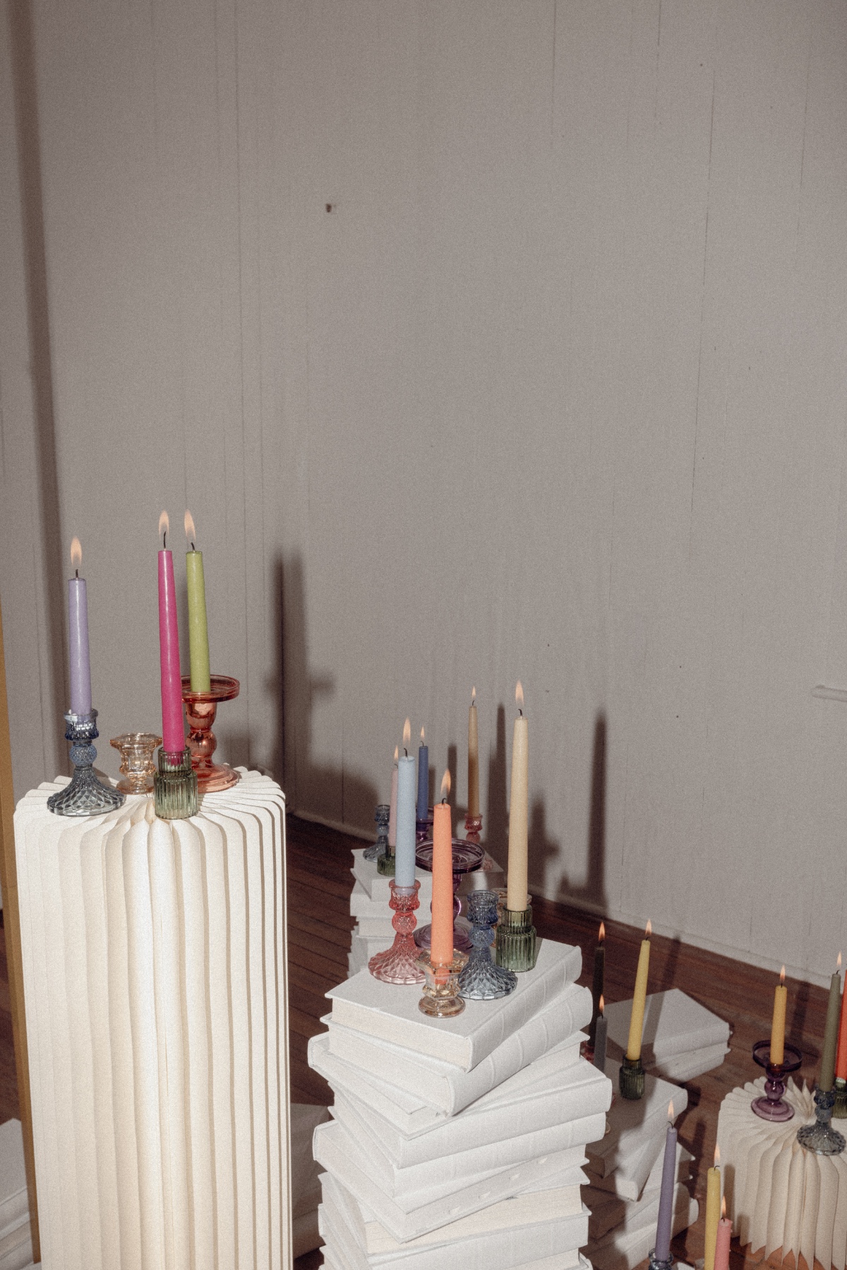 rainbow candles on white pillars for wedding ceremony