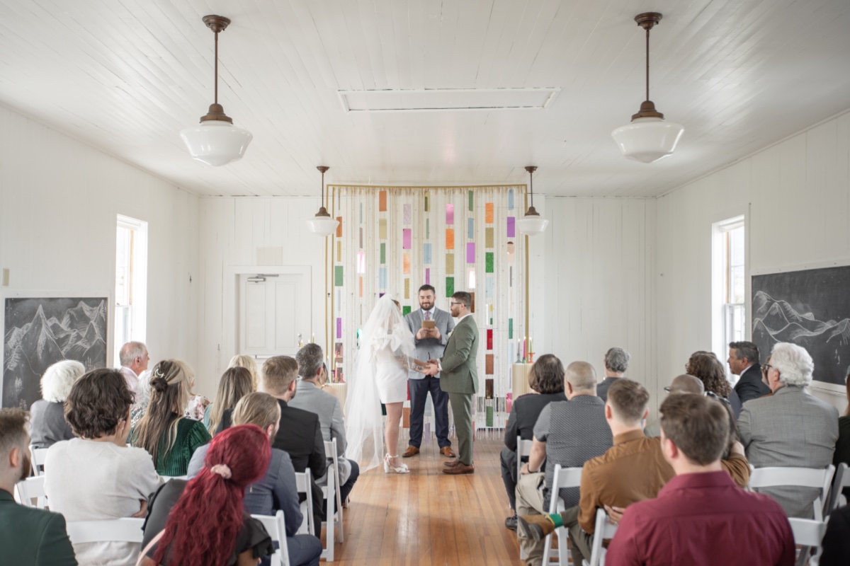 small micro wedding ceremony in a white chapel