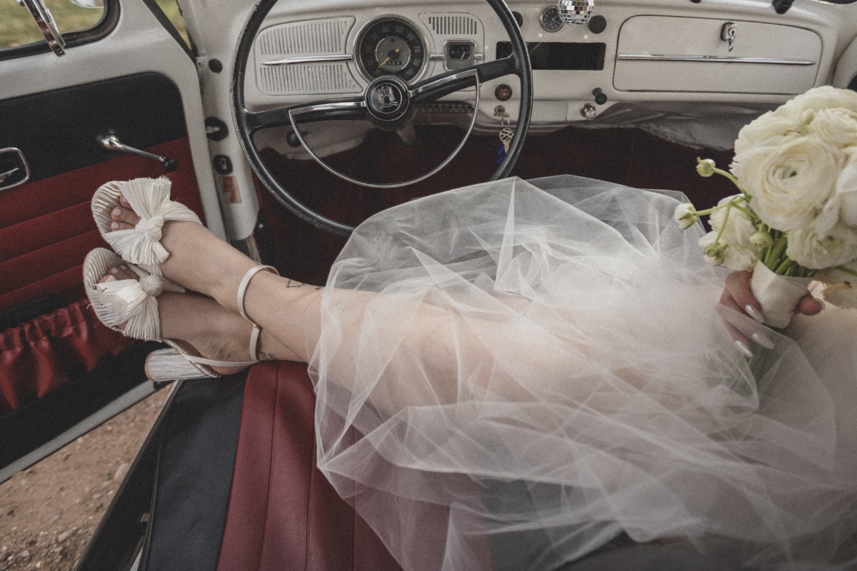 bride in vintage wedding getaway car