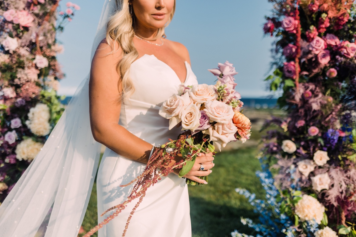 bride in structured dress with pastel bouquet