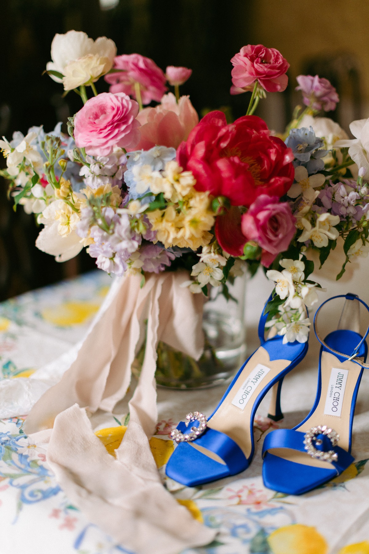 colorful peony bouquet and blue satin jimmy choo shoes