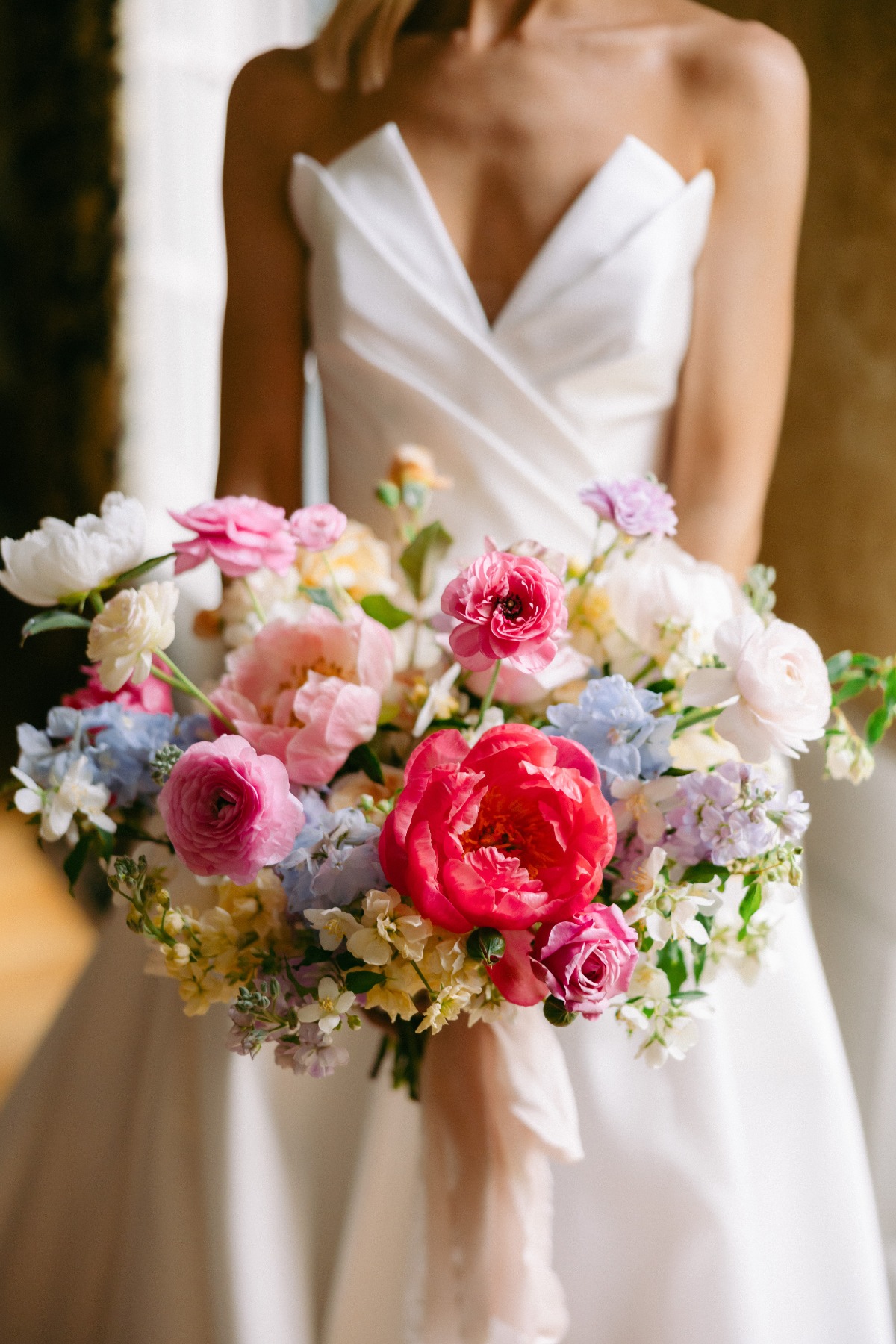 modern pleated wedding gown with colorful bouquet