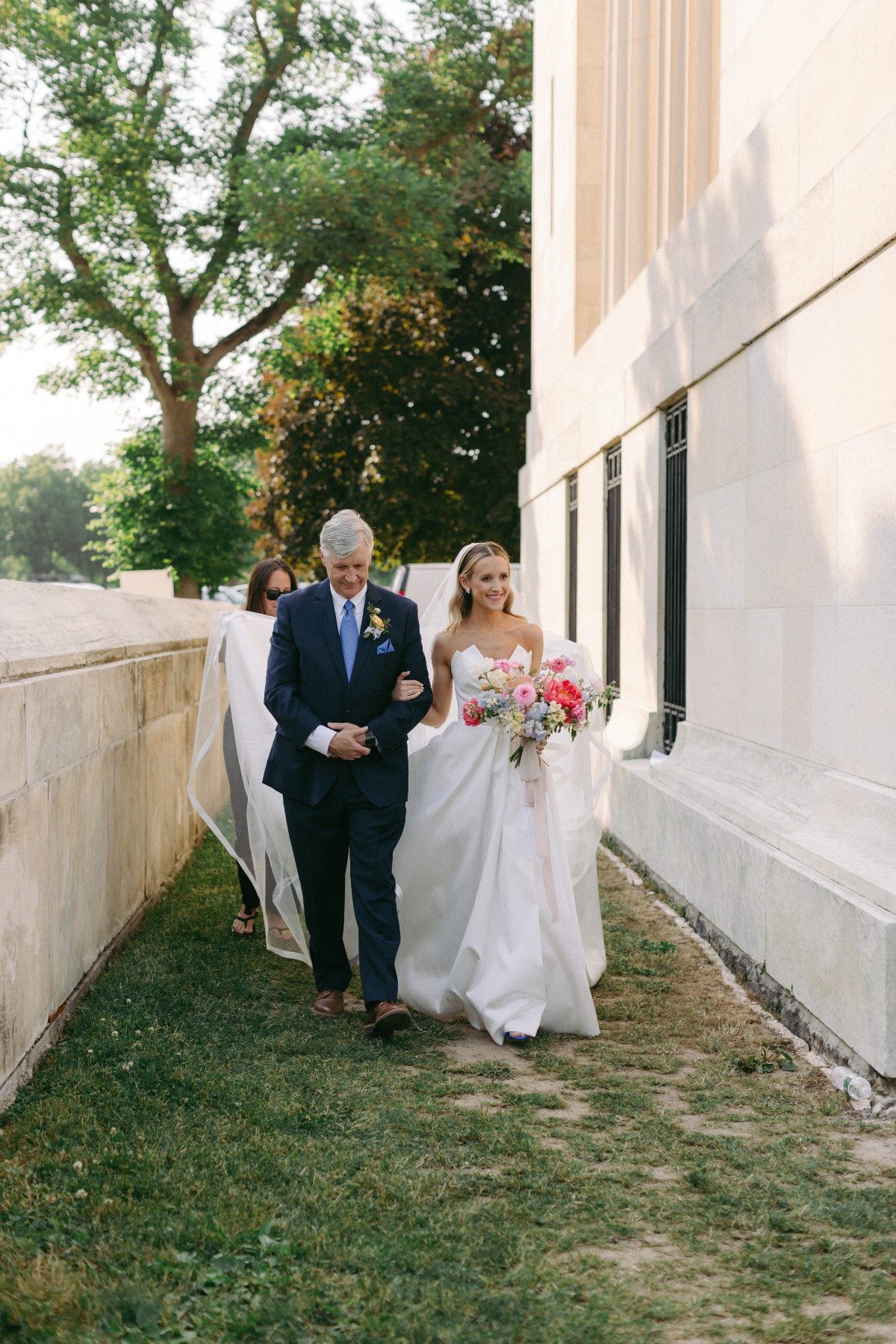 father walking bride down the aisle in outdoor ceremony