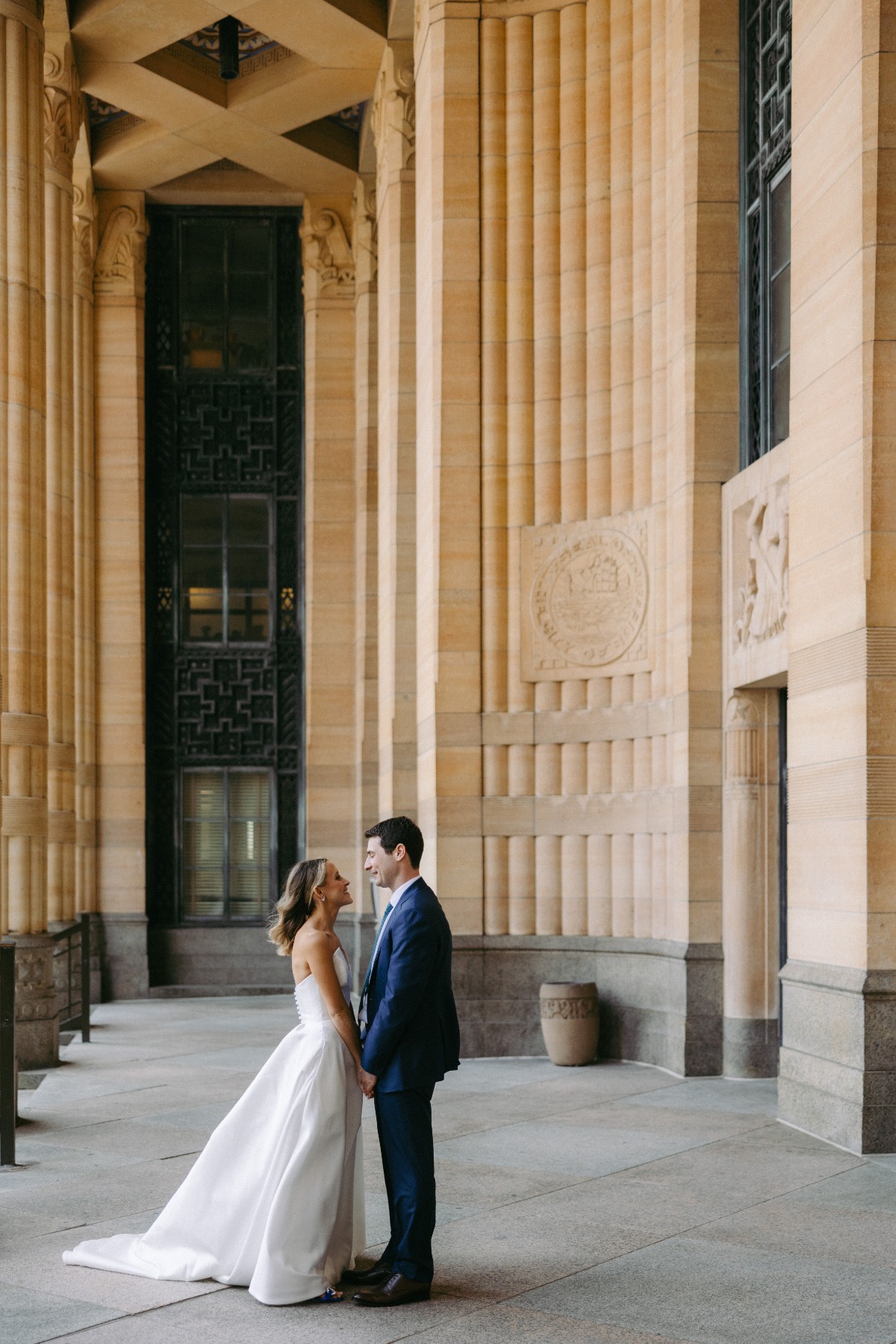 bride and groom first look among tall columns