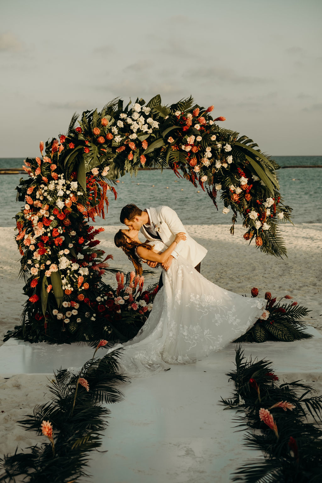 large tropical greenery and red flower semi circle