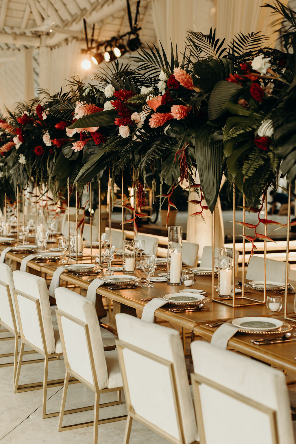 tall tropical greenery and red flower centerpieces