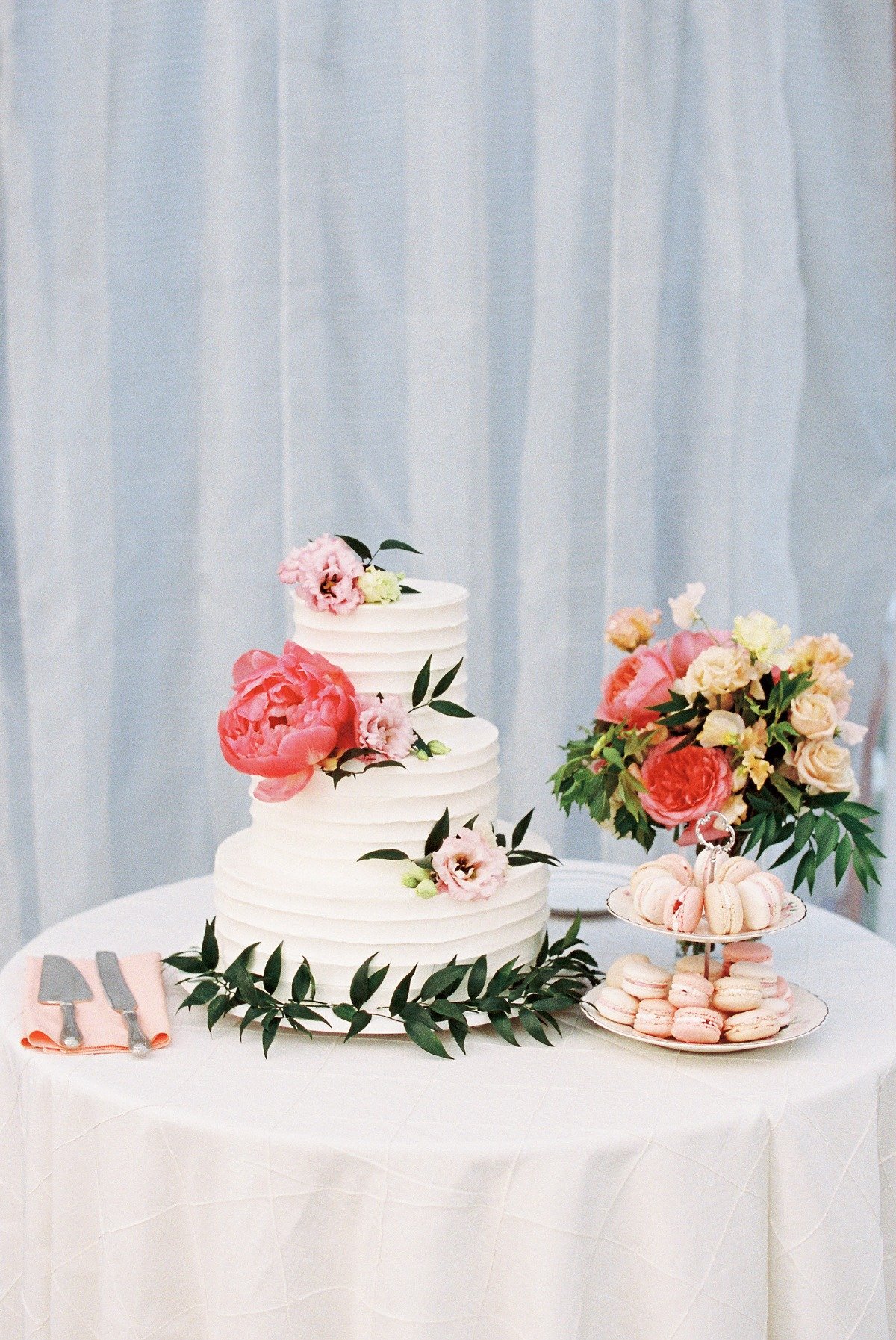 butter cream wedding cake with fresh peonies and macarons