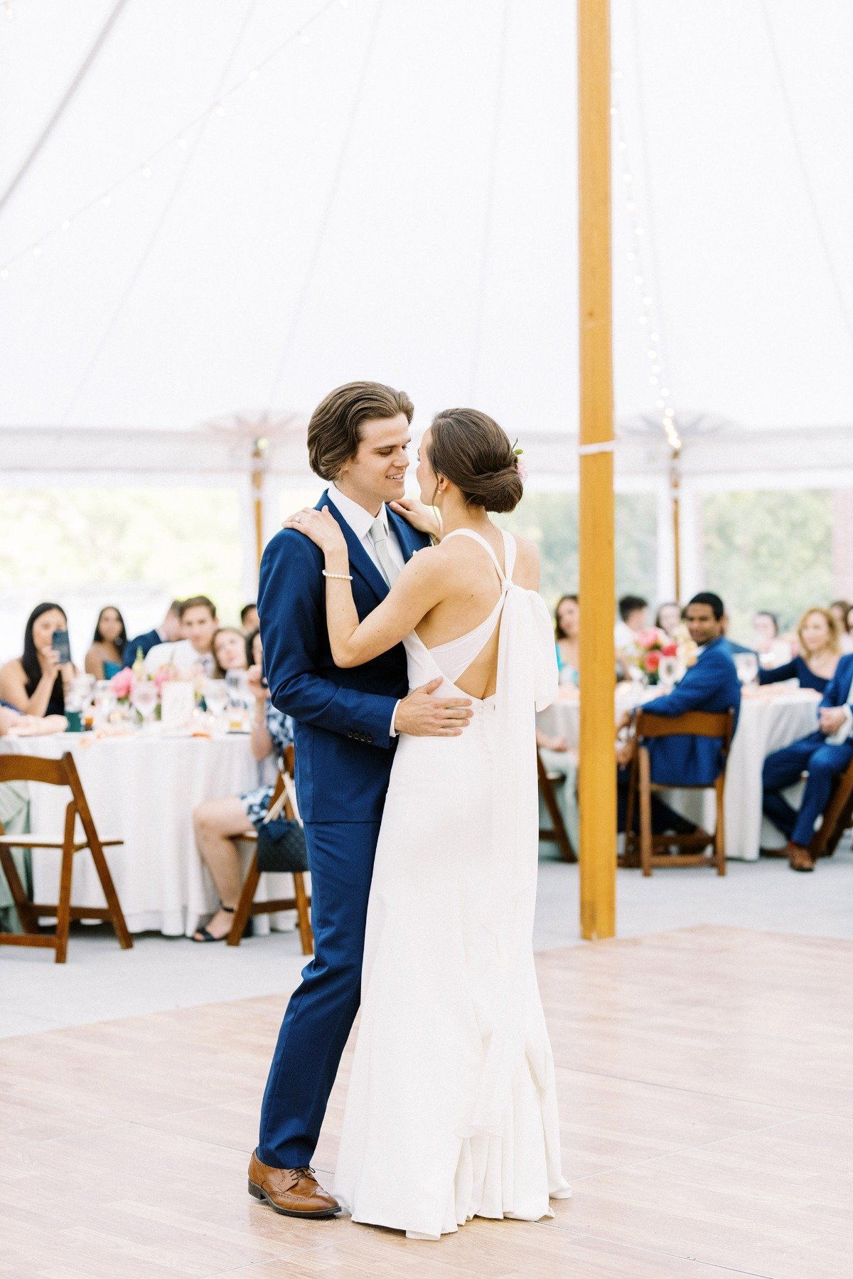 bride and groom dance at tented reception