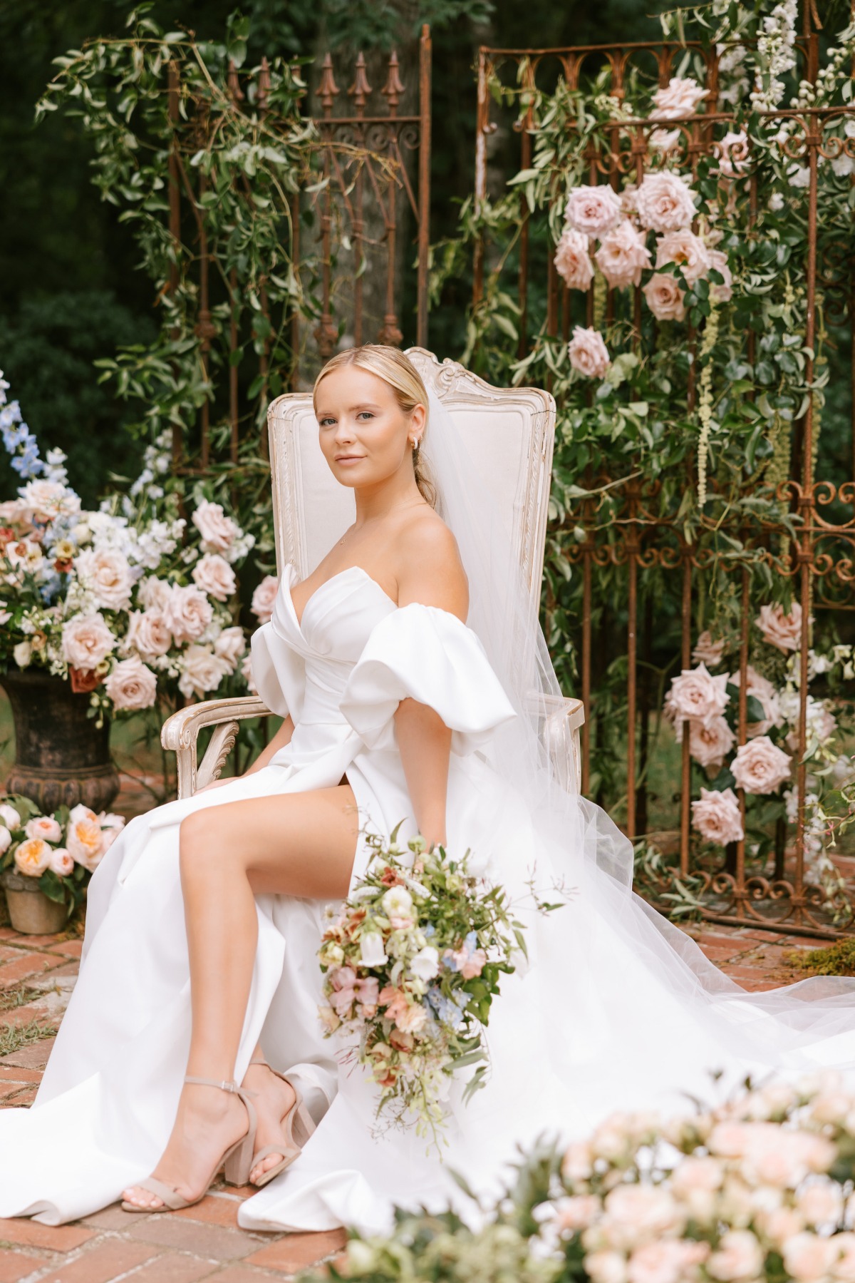 bride in off the shoulder modern a line gown with flowers