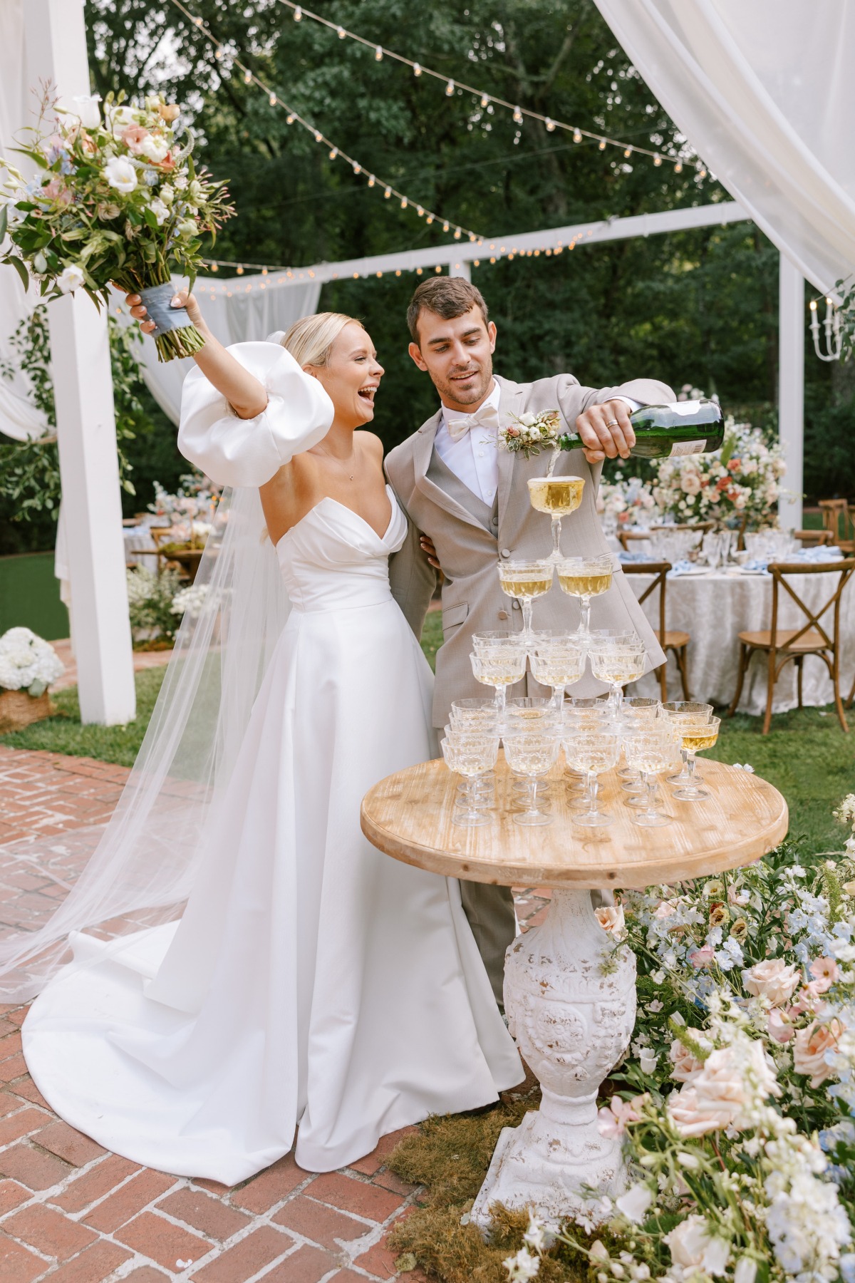 bride and groom pouring champagne tower