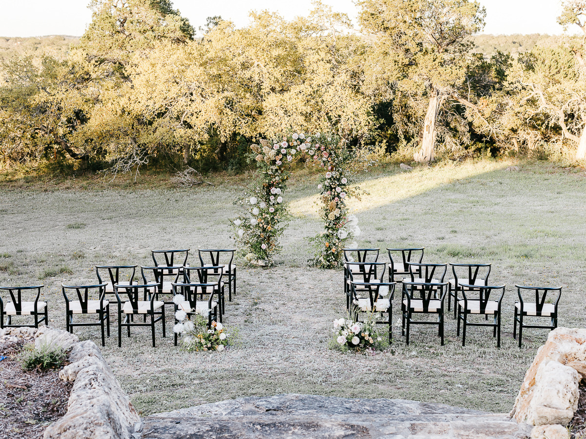 outdoor modern wedding ranch wedding ceremony with floral arch