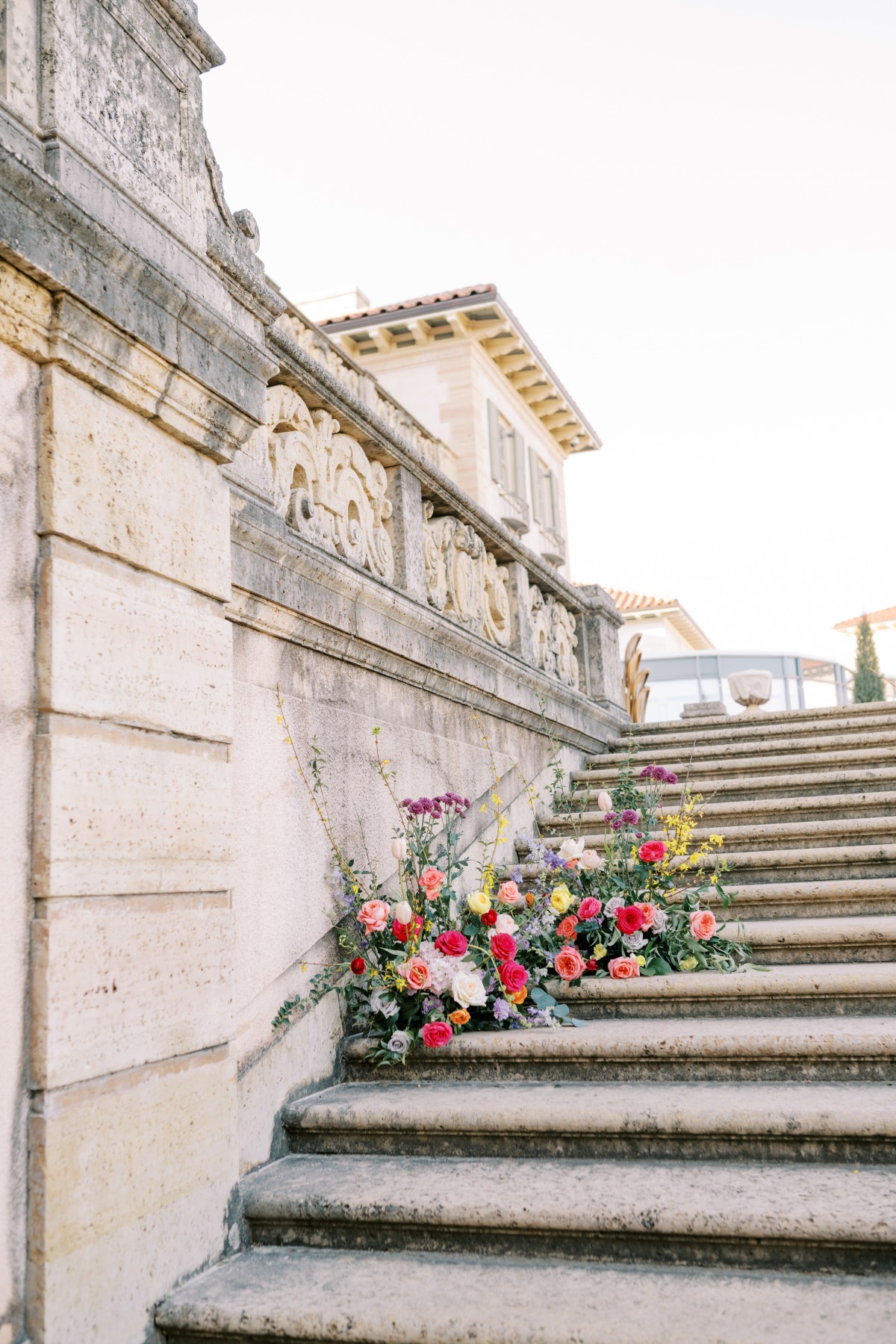 Colorful rainbow floral arrangements for cascading steps 