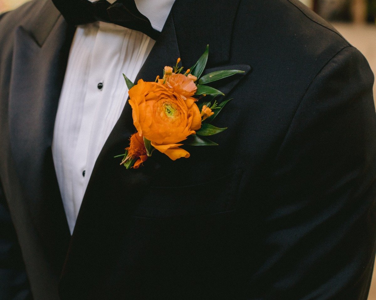 groom with orange boutonnière