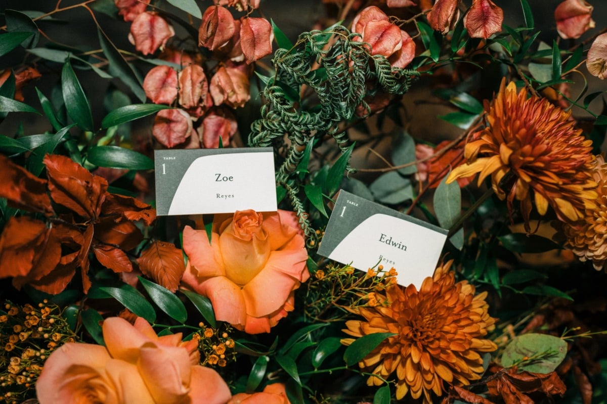 orange wedding flower arrangements with escort cards