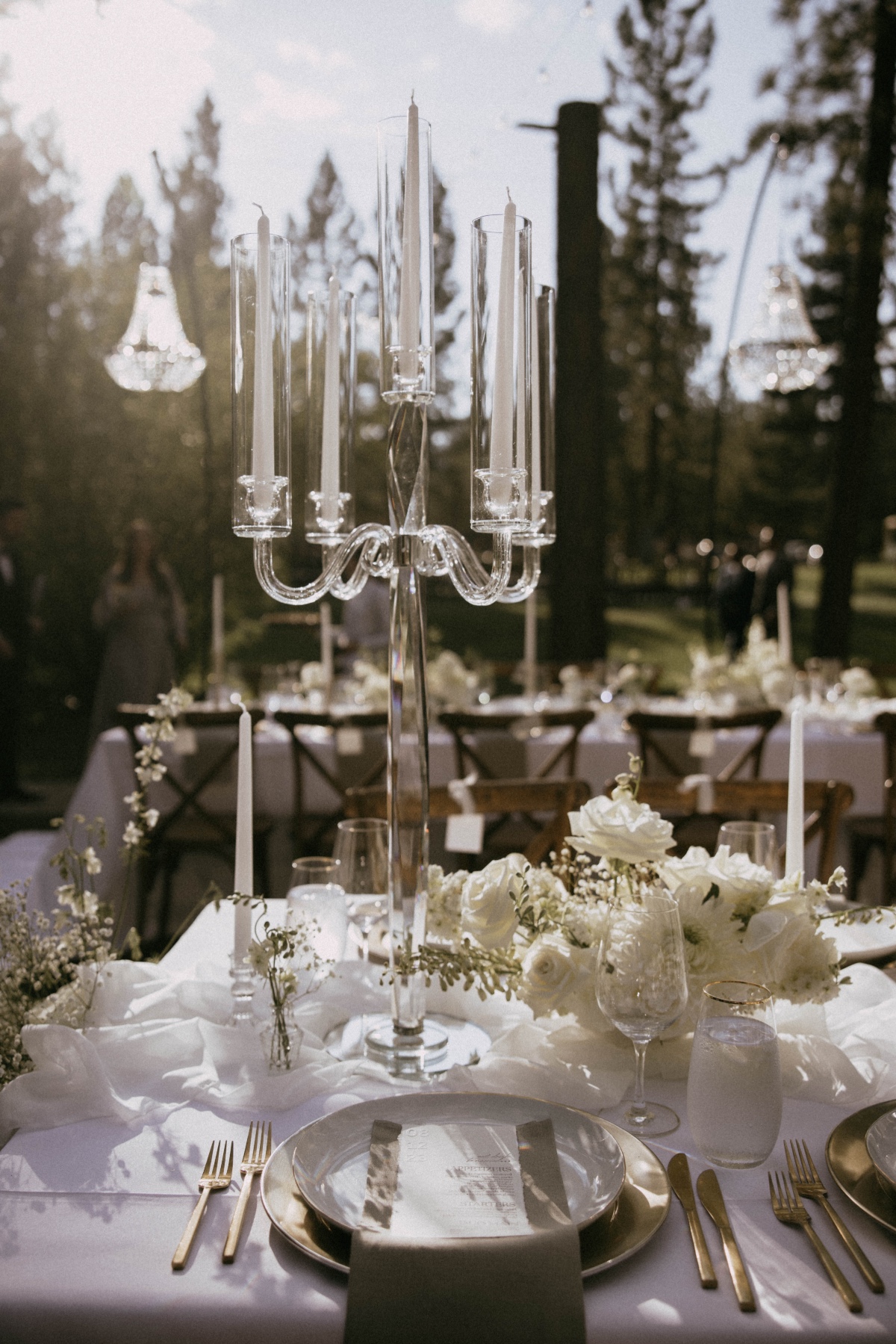 hollow glass candelabras on all white tablescape