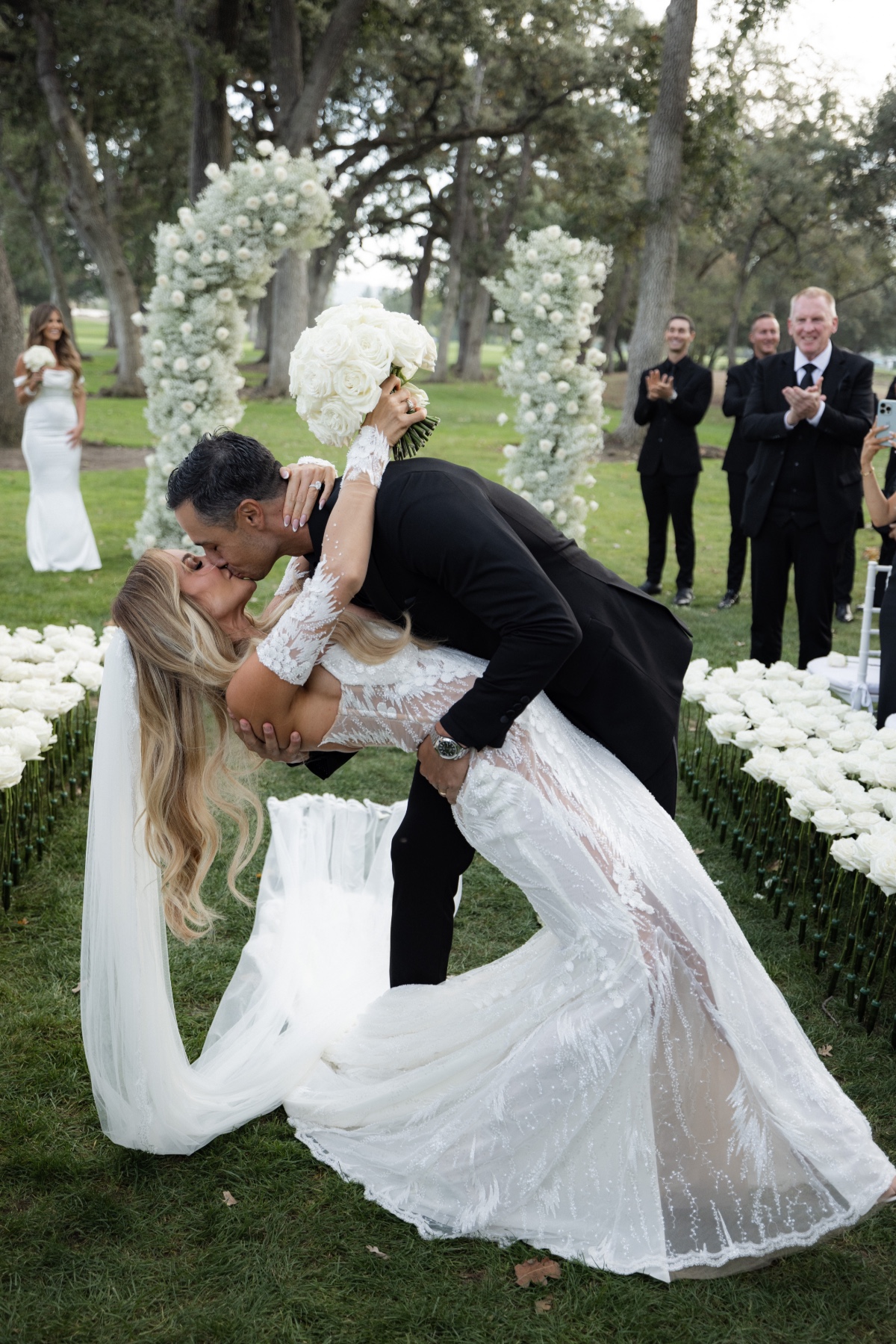 bride and groom kiss at black and white garden wedding