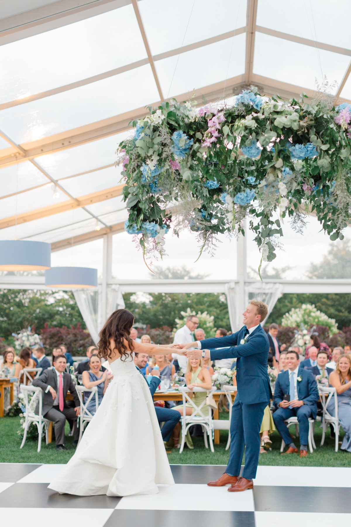 hanging floral arrangement over dancefloor at wedding reception