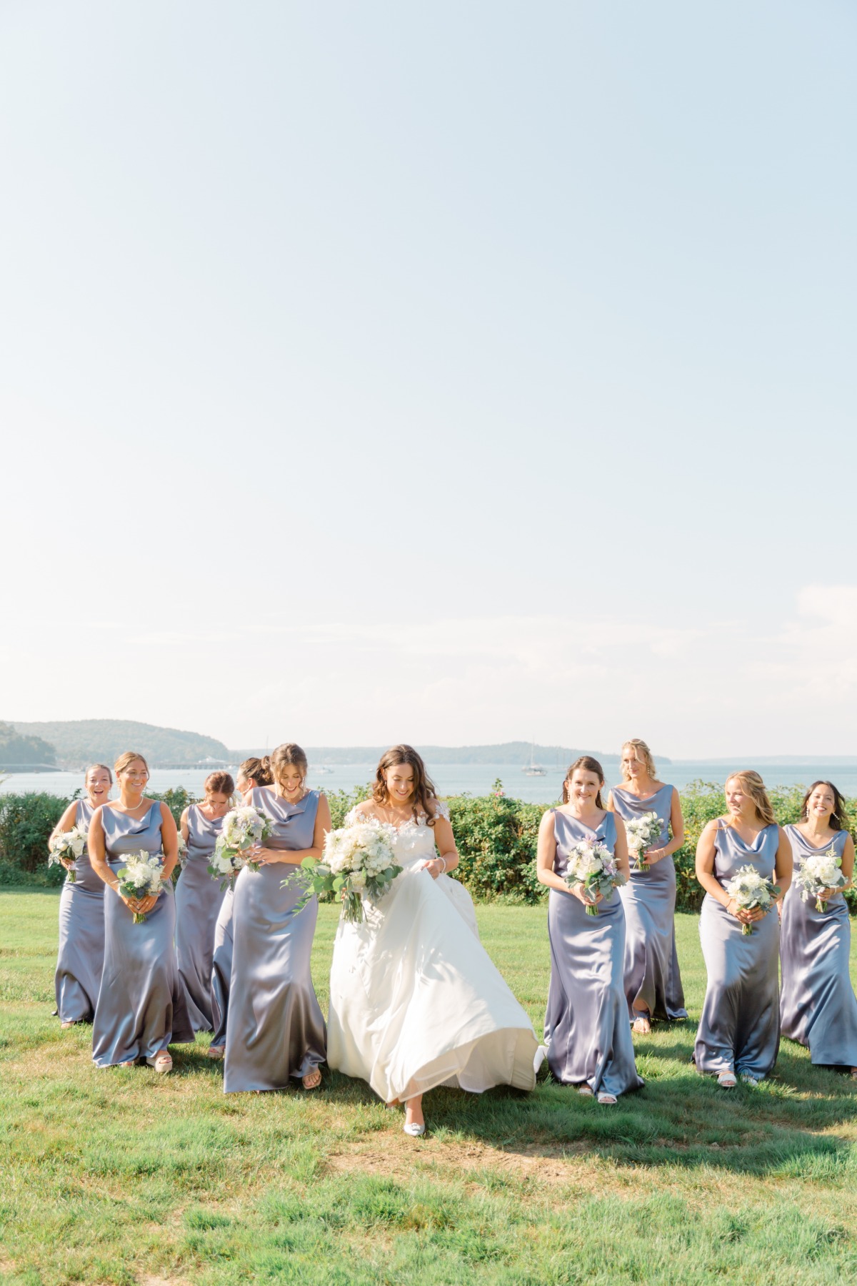 bride and bridesmaids in purple on maine coastline