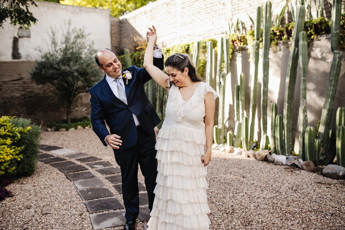 groom twirls bride in mexican garden