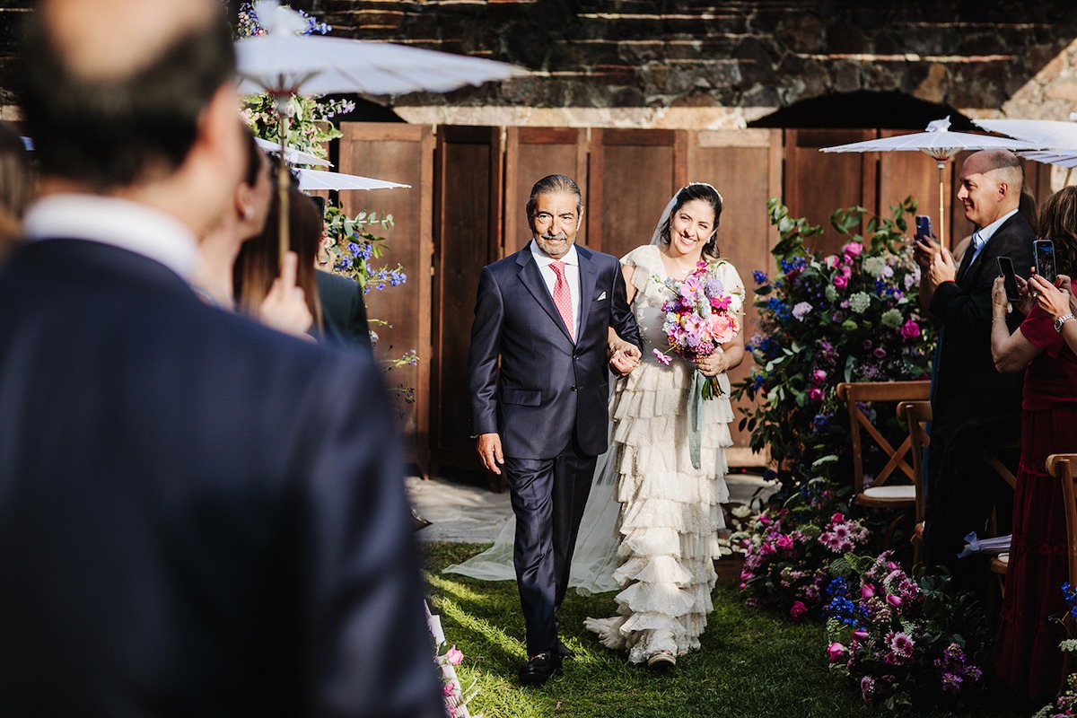 escorting bride down the aisle at garden wedding