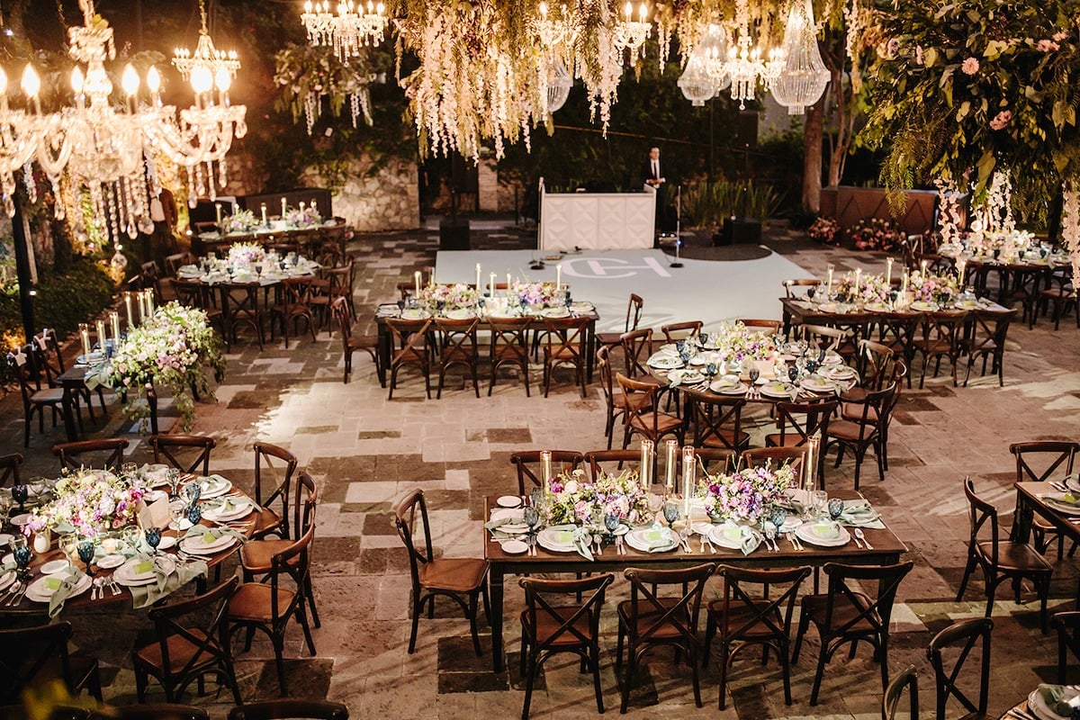 wedding reception with crystal chandeliers and hanging florals