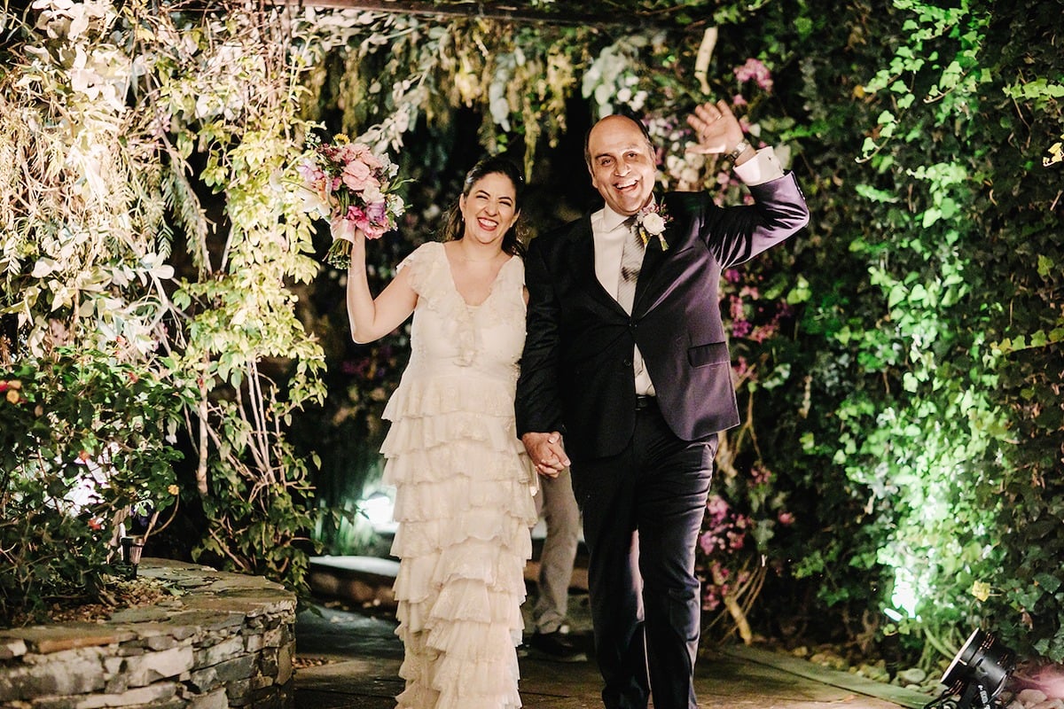 bride and groom enter garden themed reception