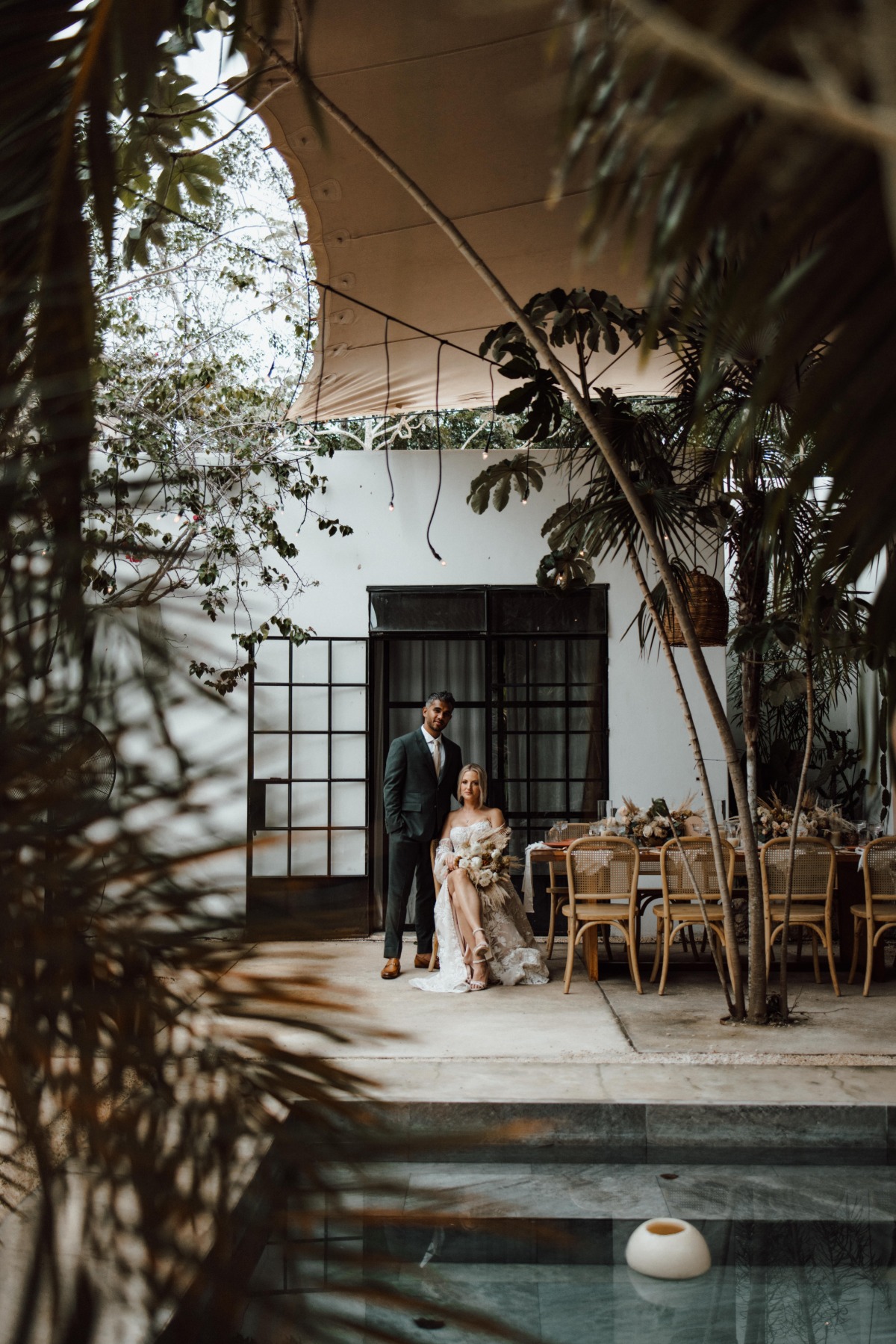 Bride and groom at modern bohemian reception table at Kima Tulum