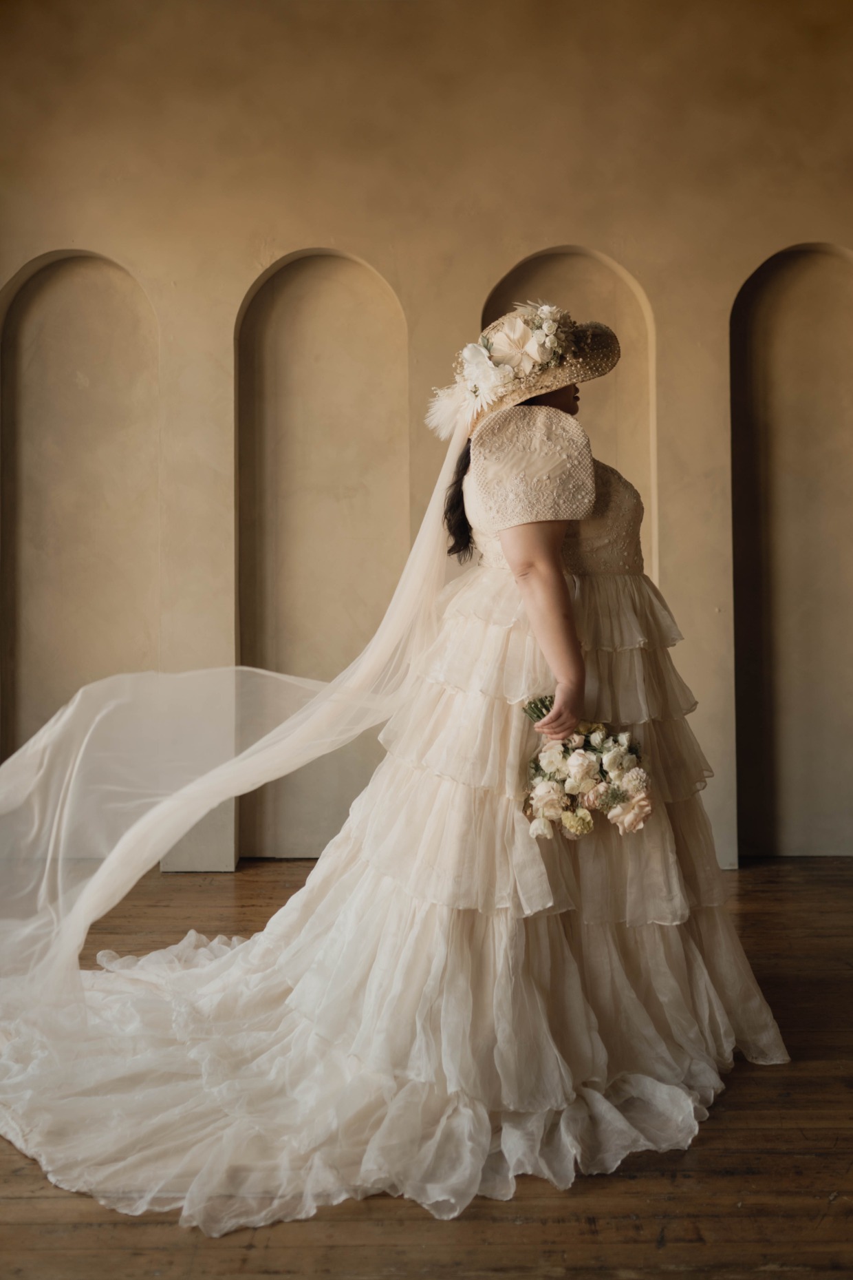 straw hat veil and sustainable tiered wedding dress by Silviyana & Community